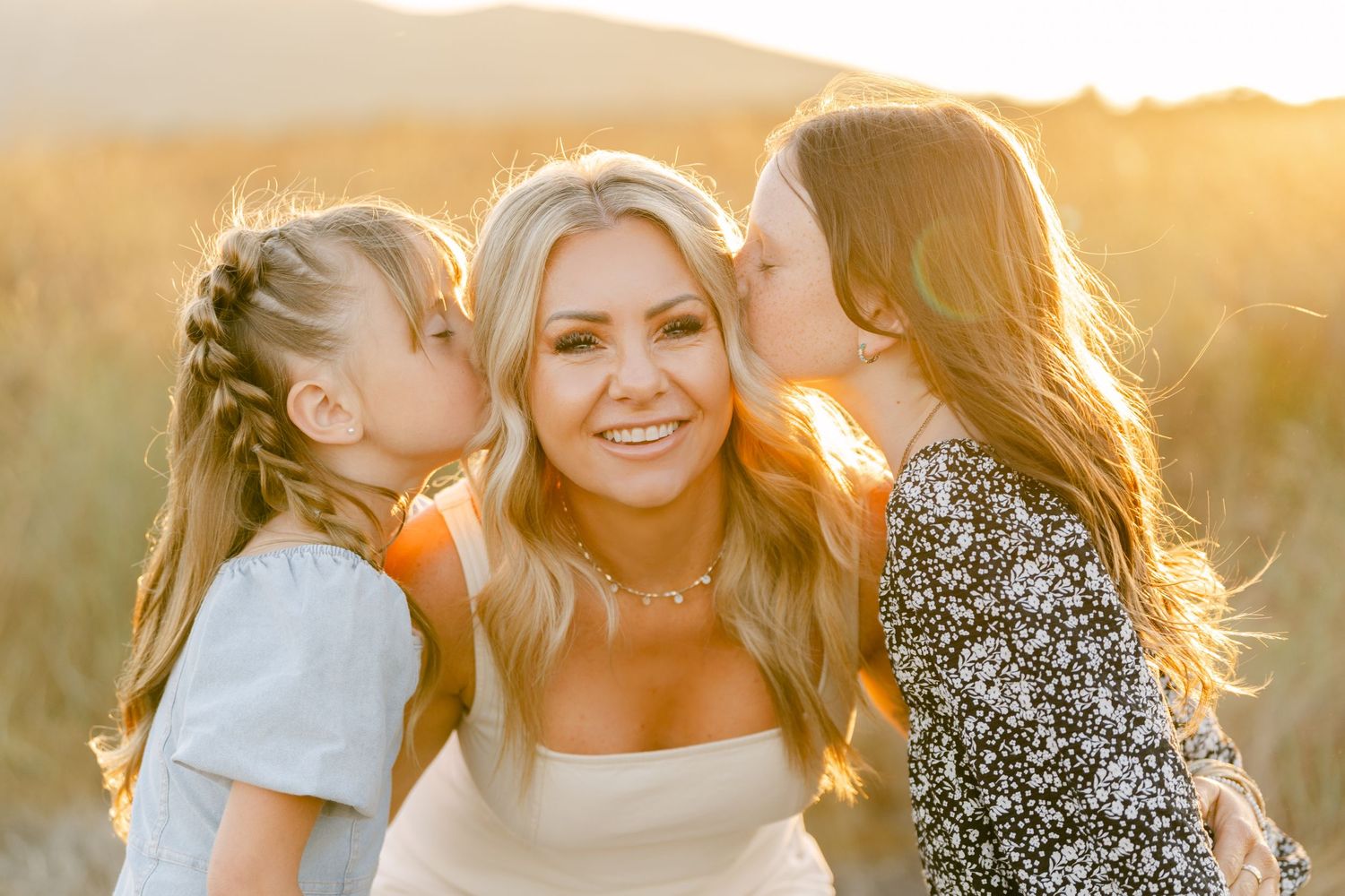 Joyful moment captured in warm sunset light with mountains in background.