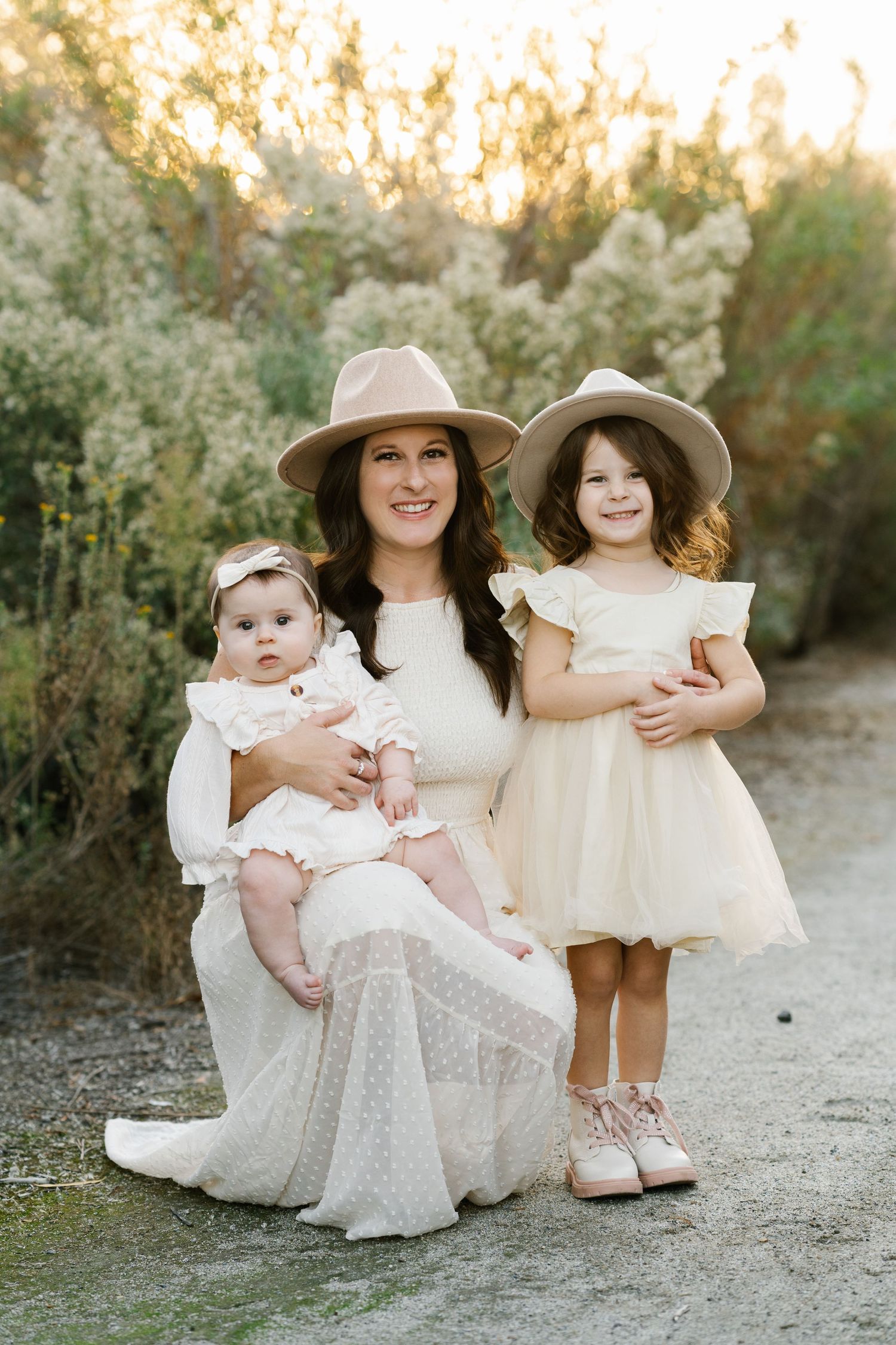 Family portrait in neutral colors against sunset and wild grasses.