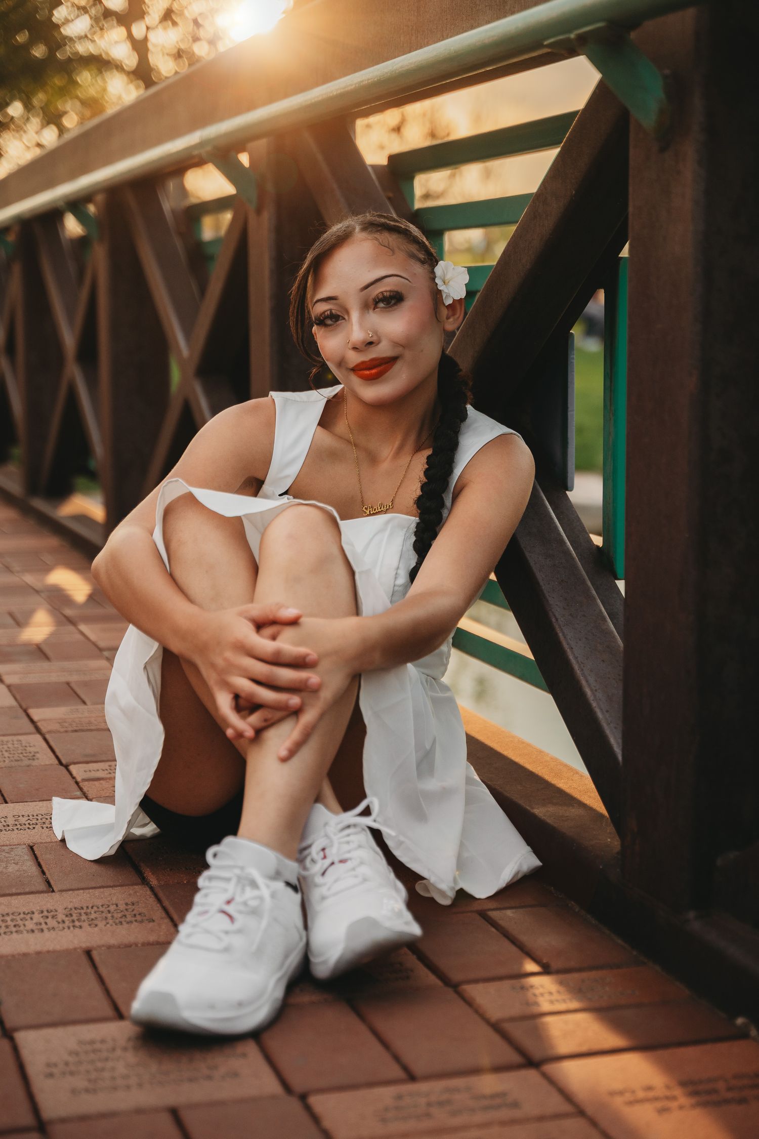 Close-up shots of a white sneaker and dress on a wooden deck in warm sunlight.