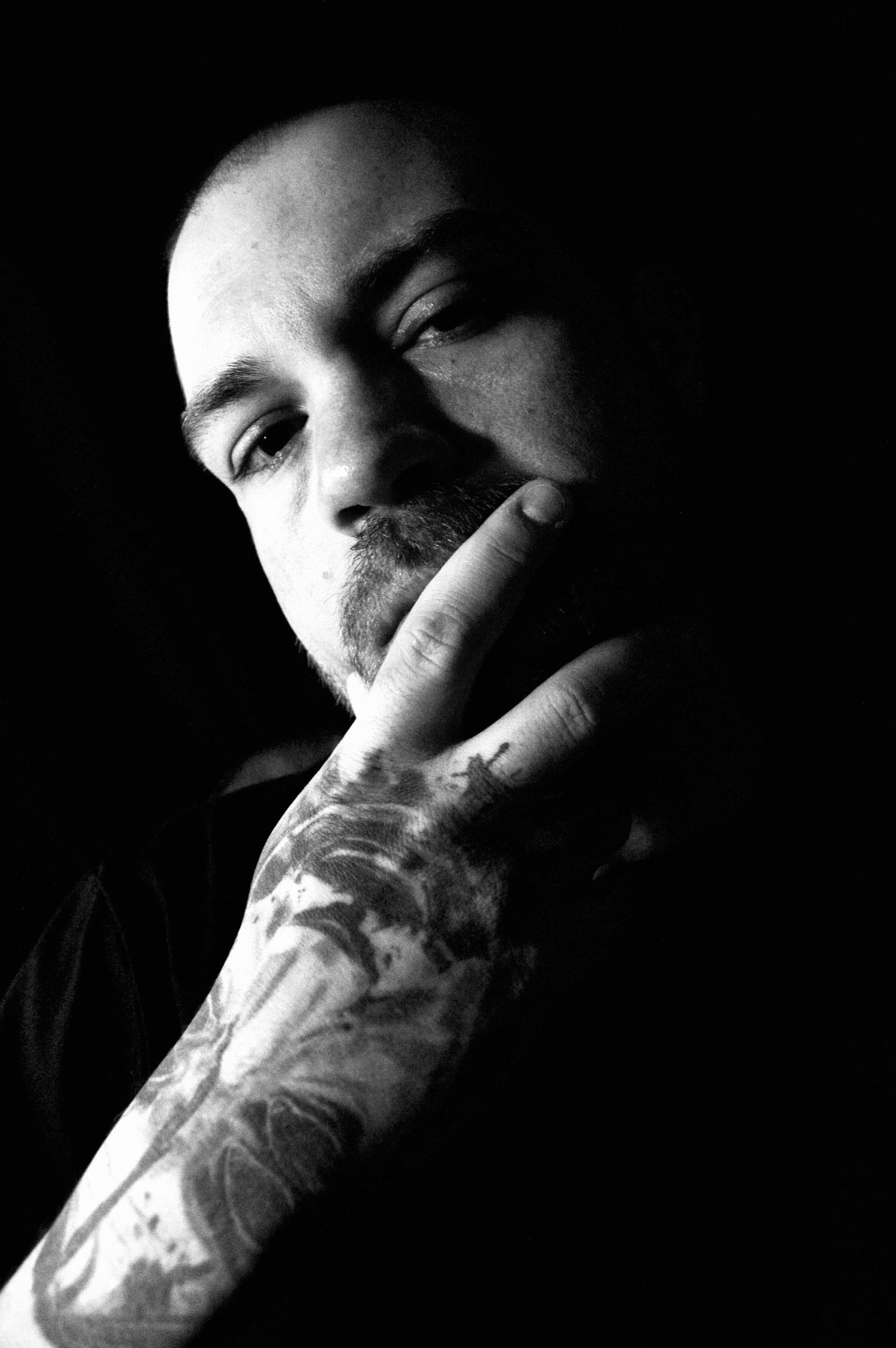 Dramatic black and white portrait series showing contemplative expressions in low light in Denver, Colorado