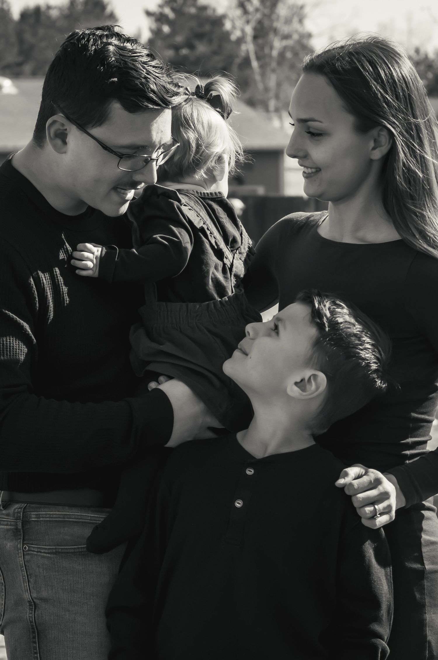 Sweet candid moments shared between family members in black and white photography.
