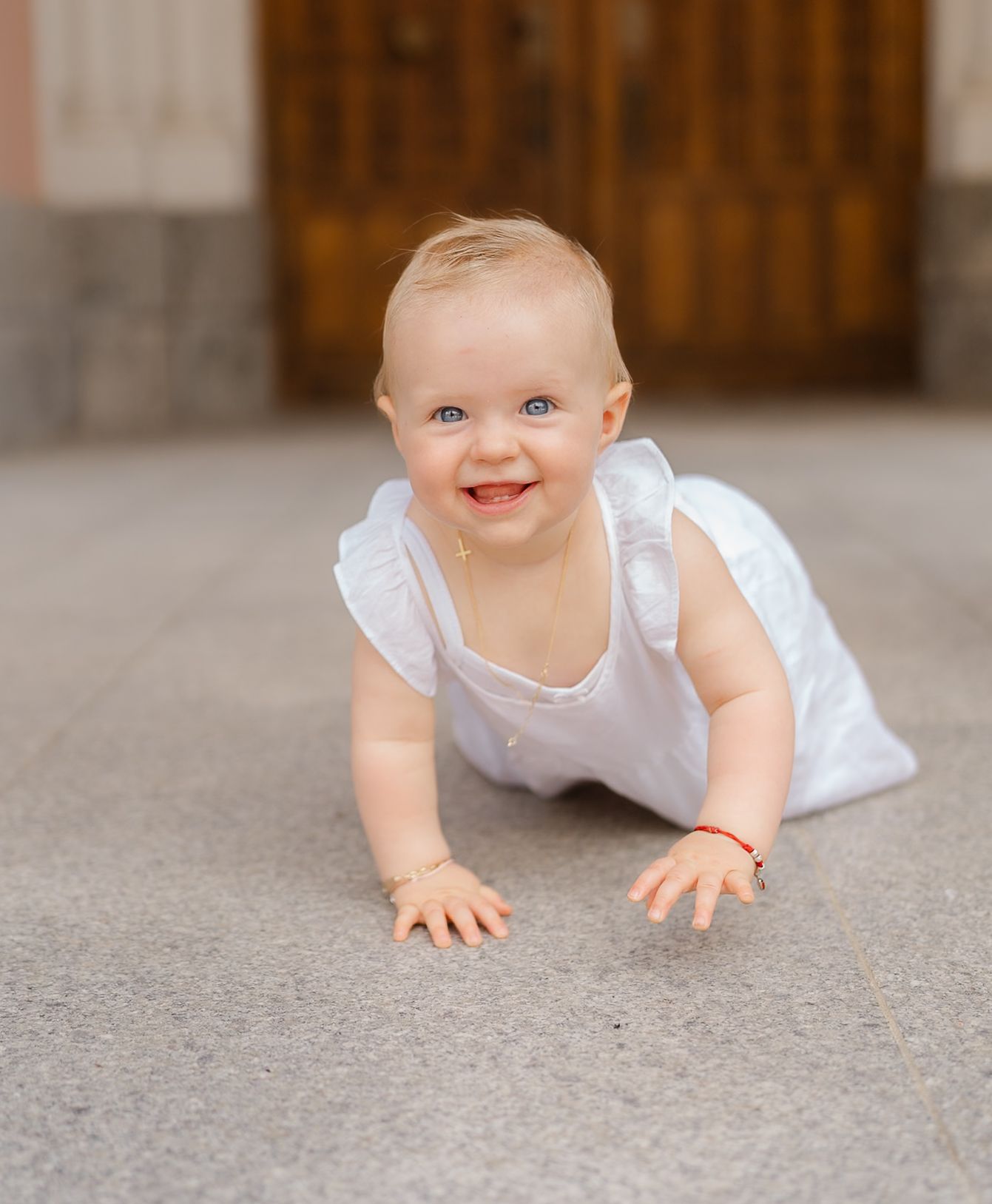 Series of photos showing a baby in white clothing crawling on gray carpet.