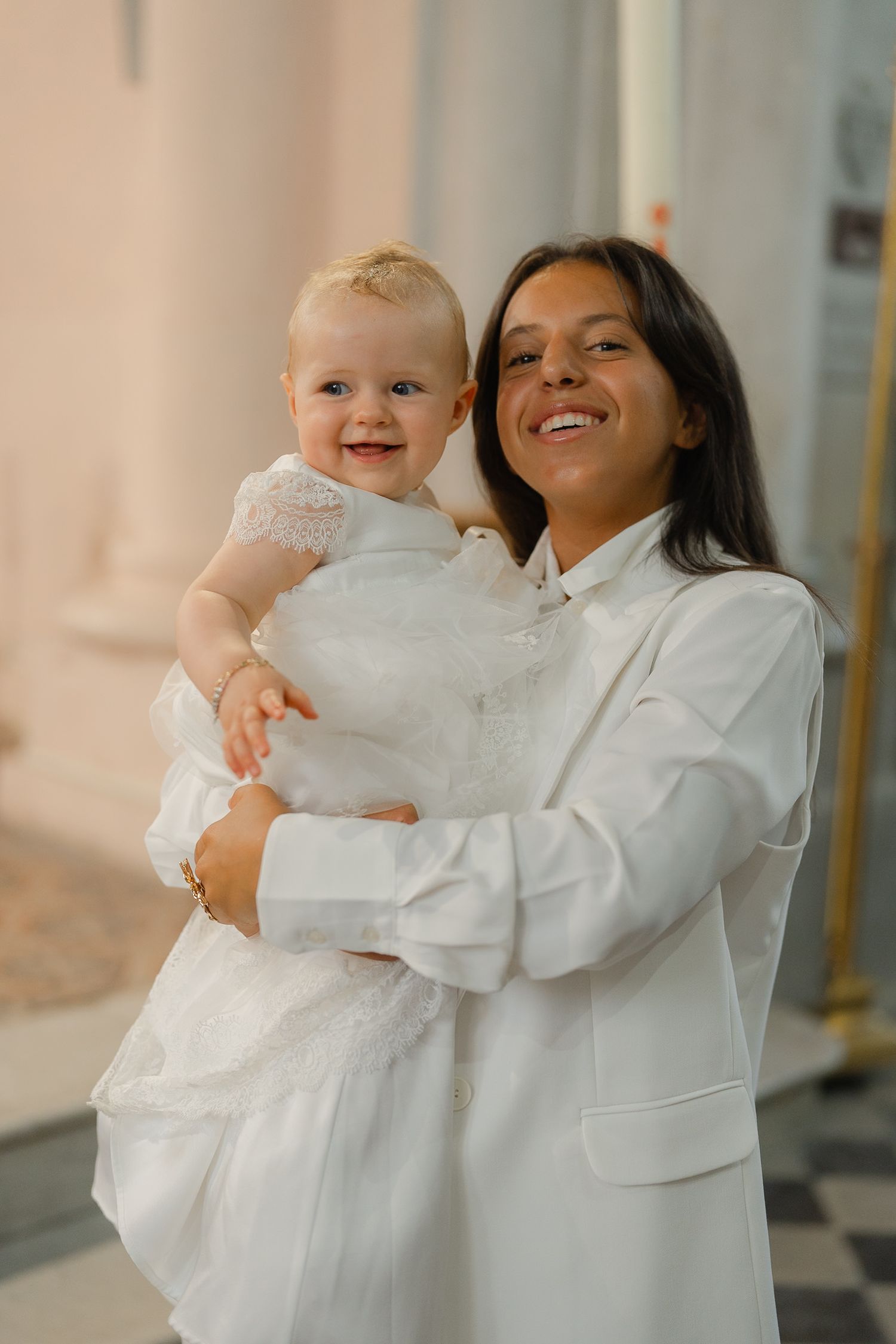 A joyful moment captured in a series of candid photos showing a baby in white being held against a bright background.
