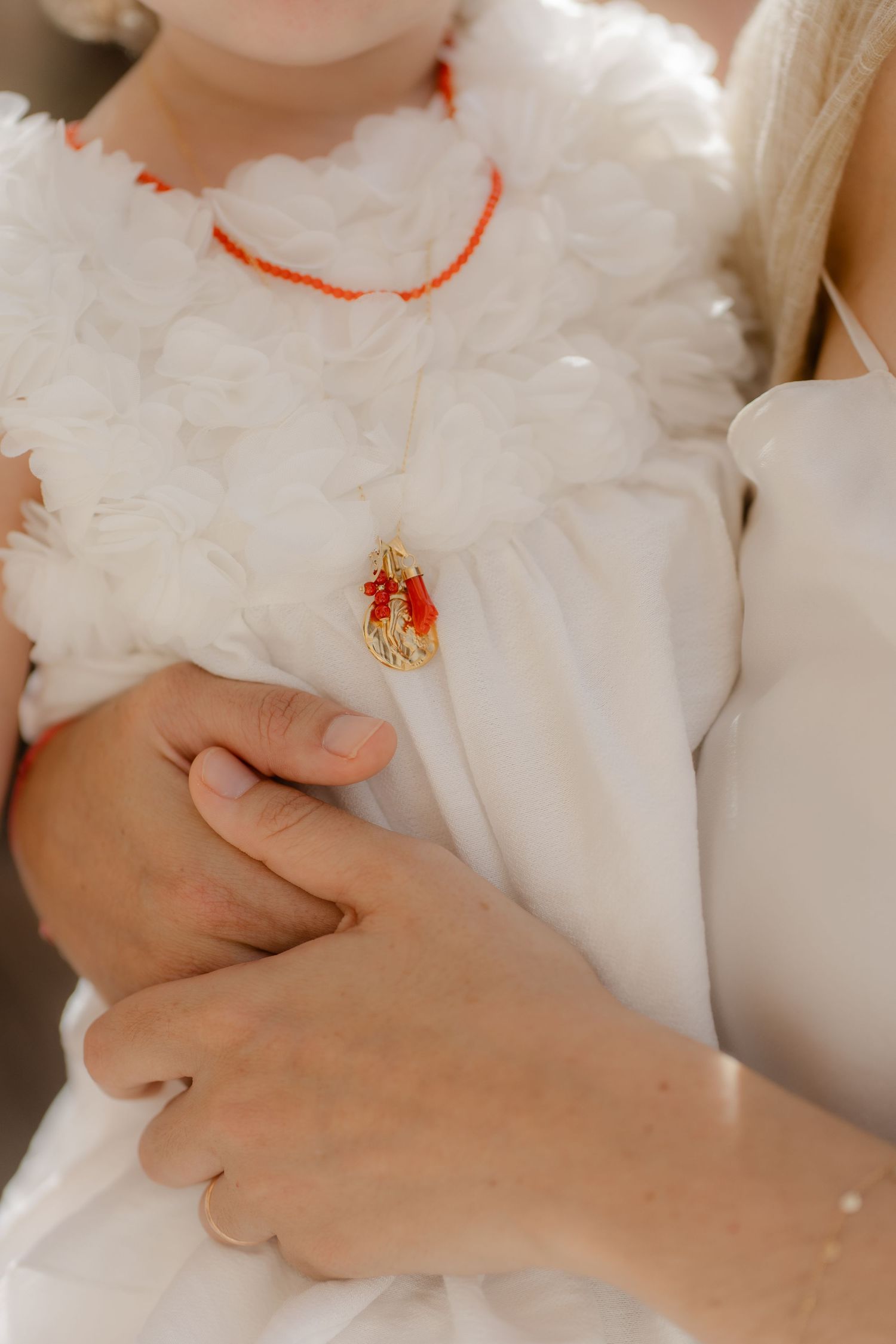 Close-up view of hands holding and caressing a soft white plush toy or stuffed animal.