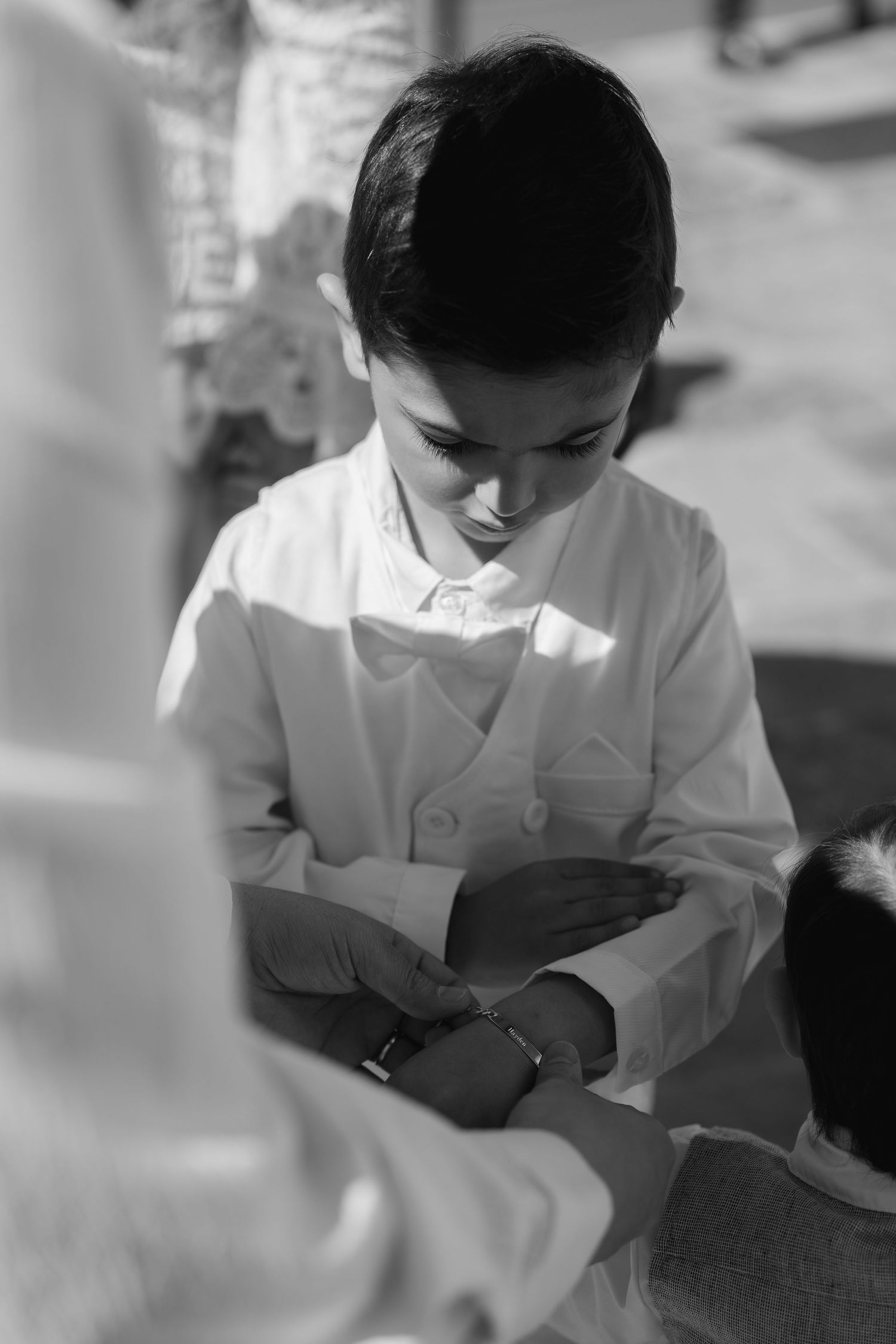 Healthcare worker in white uniform providing medical care and attention to a patient in a clinical setting.