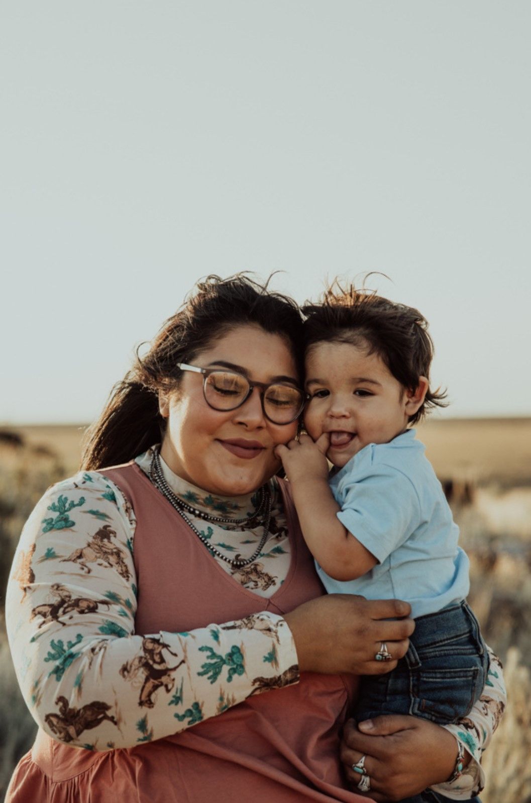 A heartwarming portrait of a parent and child sharing a laugh together.