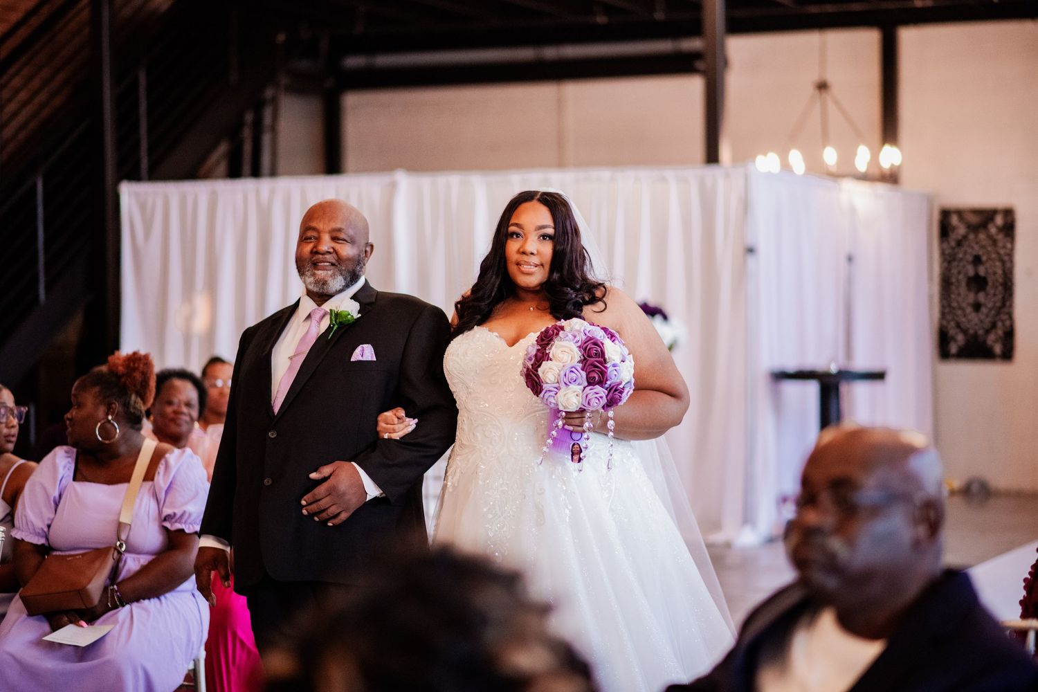 Wedding reception celebration with guests dancing in elegant decorated venue.