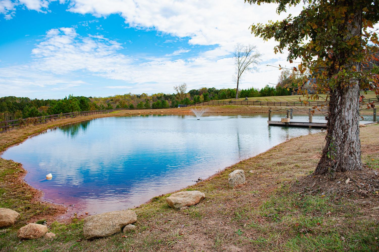 Scenic lakeside landscape with multiple panoramic views showing calm waters, trees, and natural shoreline under blue skies.
