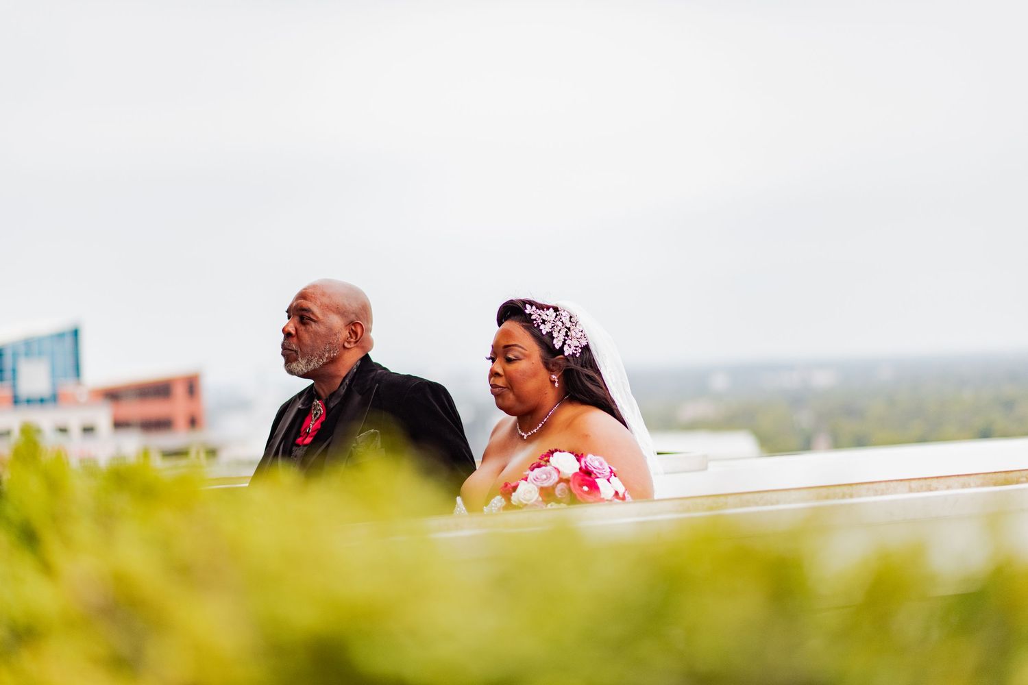 Couple enjoying a scenic view from a balcony or terrace overlooking a natural landscape.