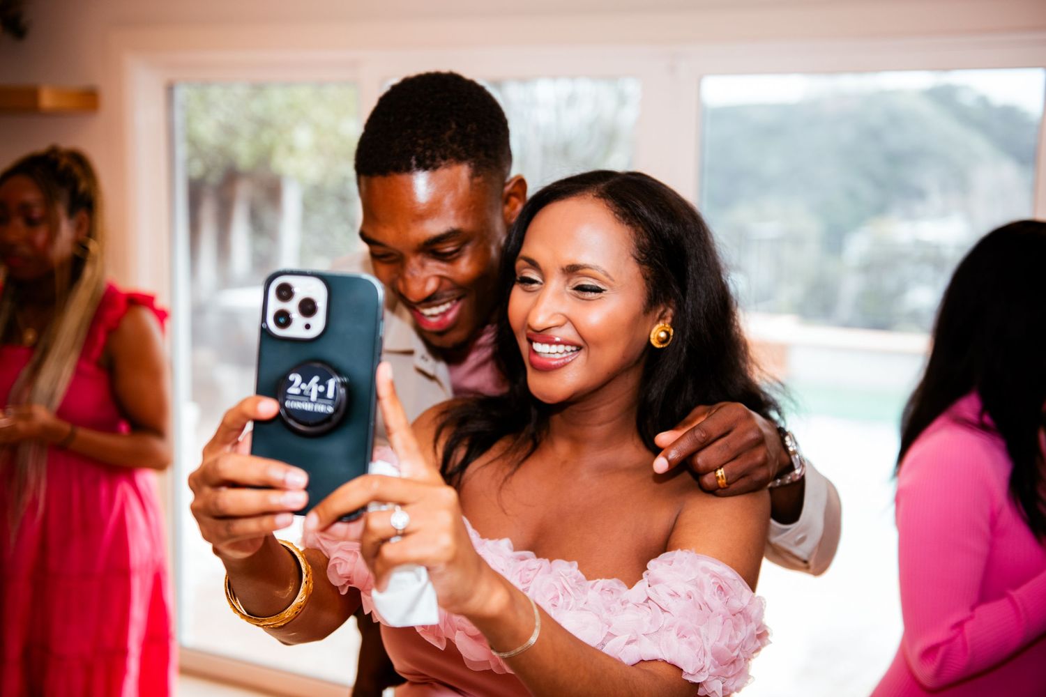 A joyful moment captured during a celebration with pink decor.