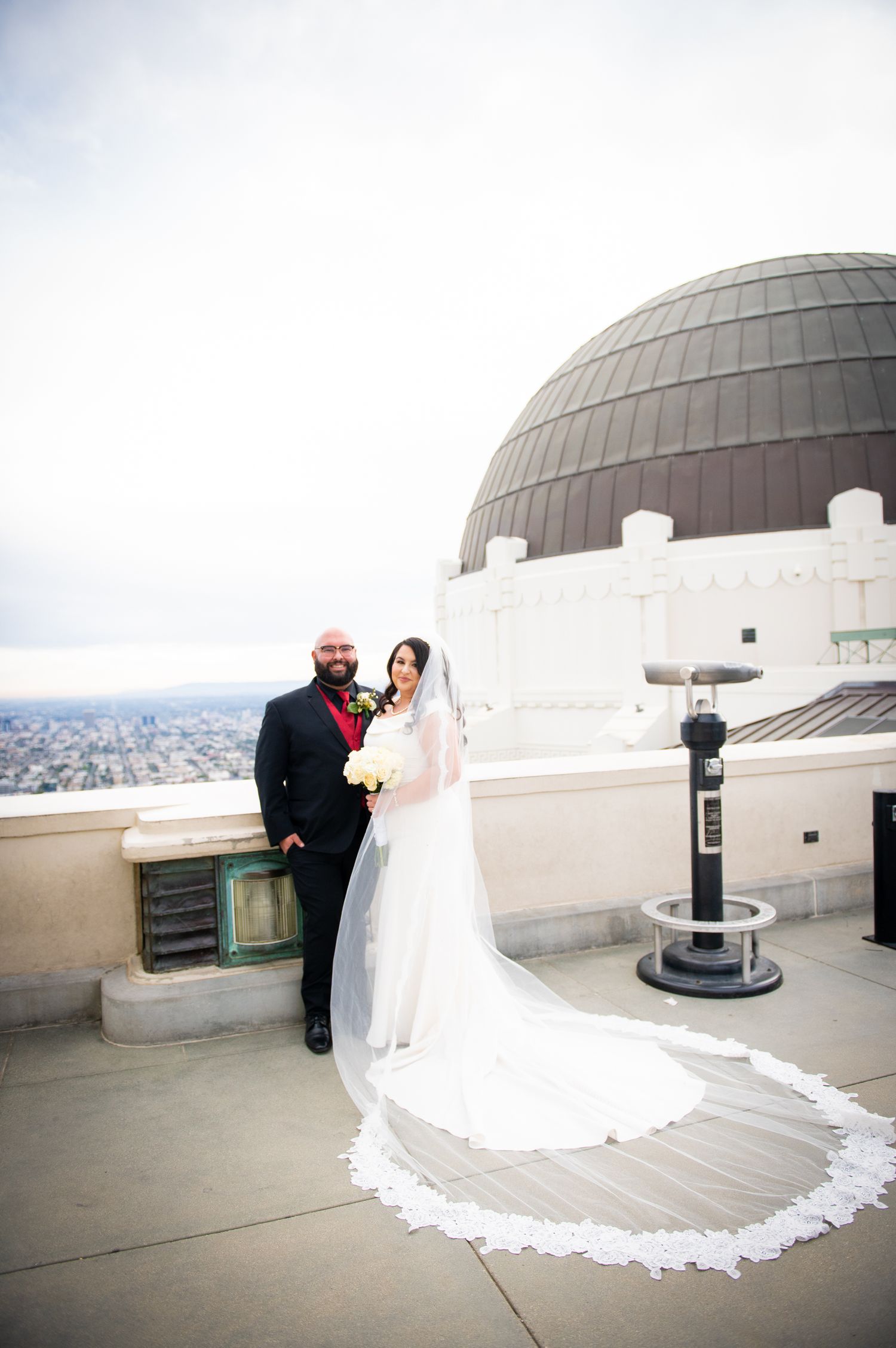 A wedding photoshoot sequence on the Griffith Observatory deck with the iconic domed structure in the background.