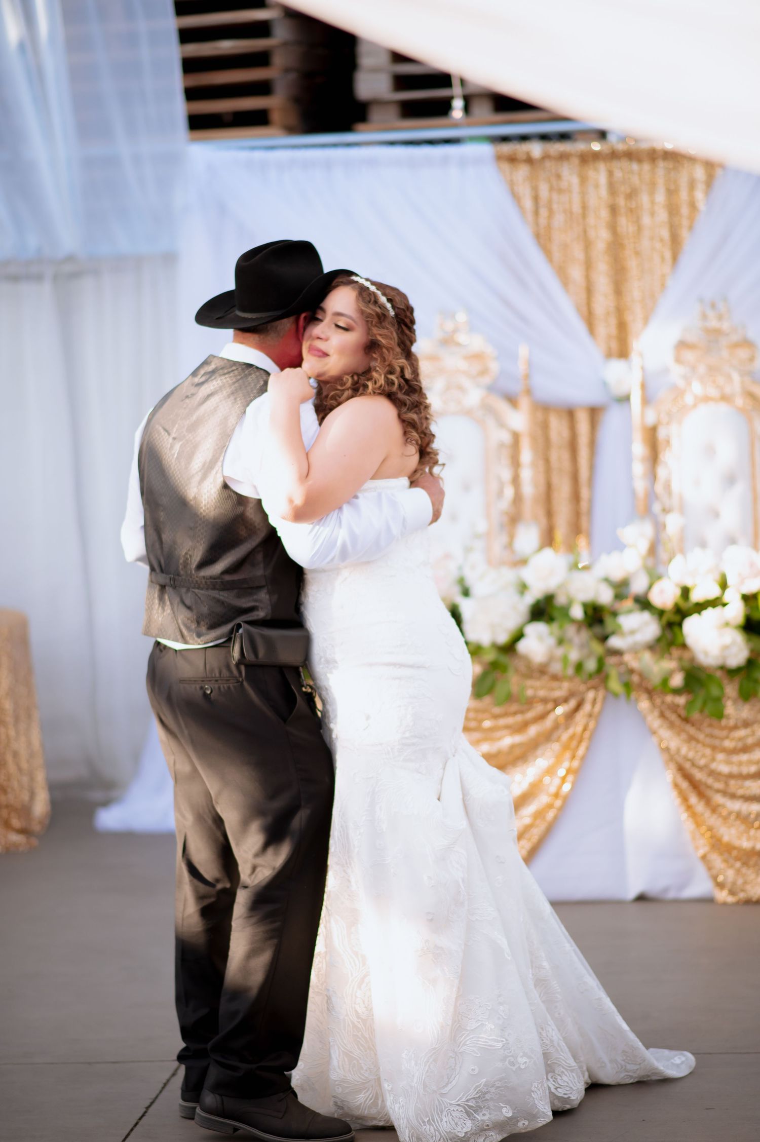 wedding dance sequence showing the Father and daughter spinning beneath elegant white drapes and golden accents.