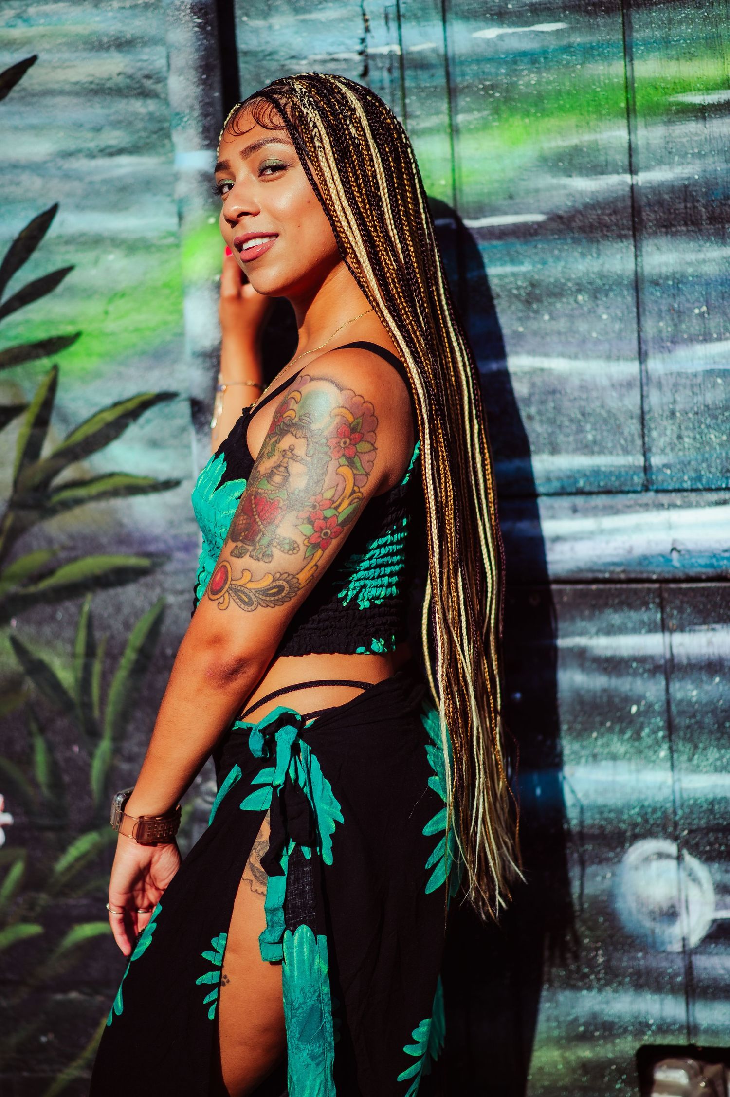 Artistic portrait series showcasing a tropical-inspired black and turquoise ensemble.