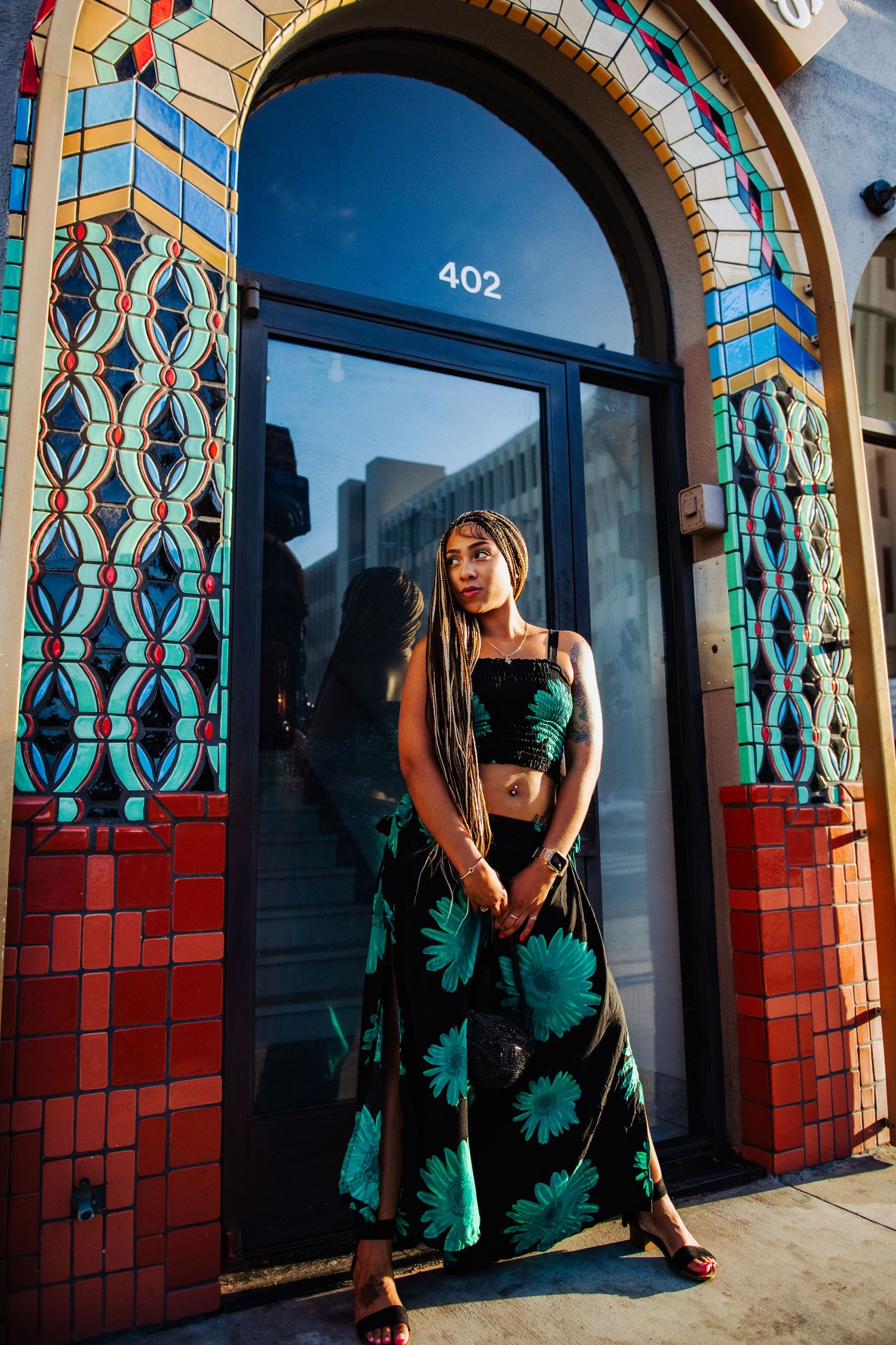 A figure poses gracefully in a sequence of frames against colorful arched doorways with geometric patterns and red tiling.