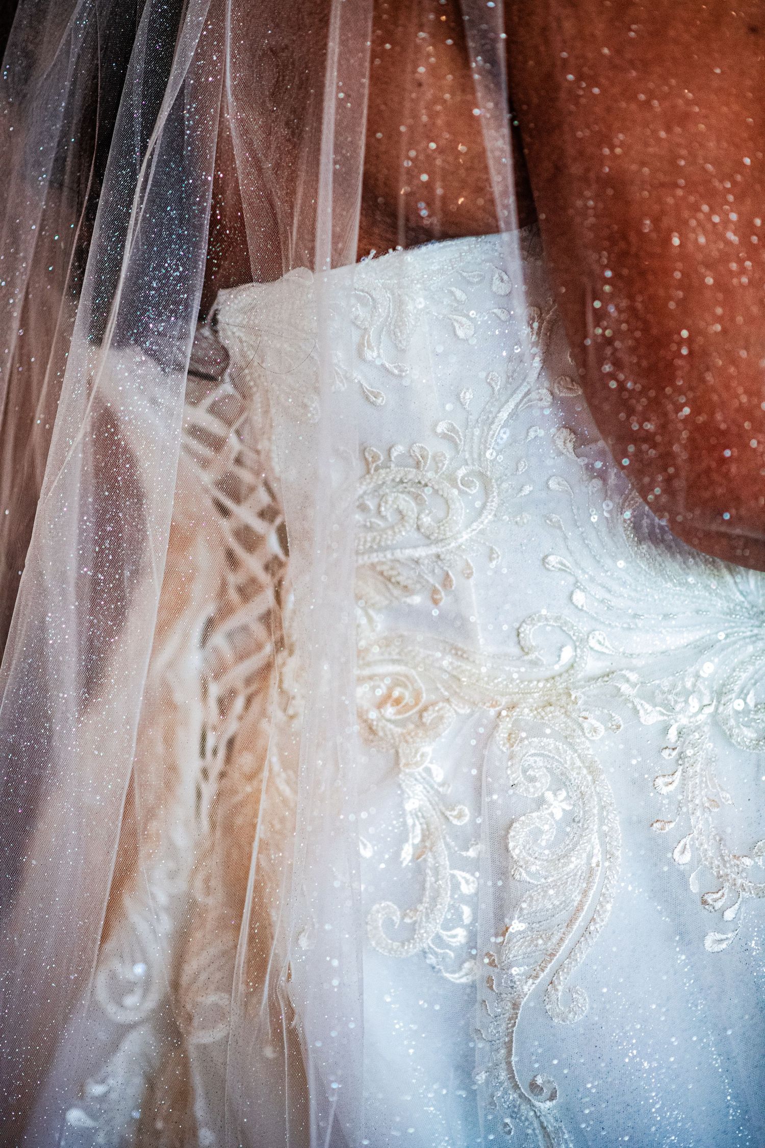 Detailed shots of intricate white lace and beadwork on a wedding dress veil.