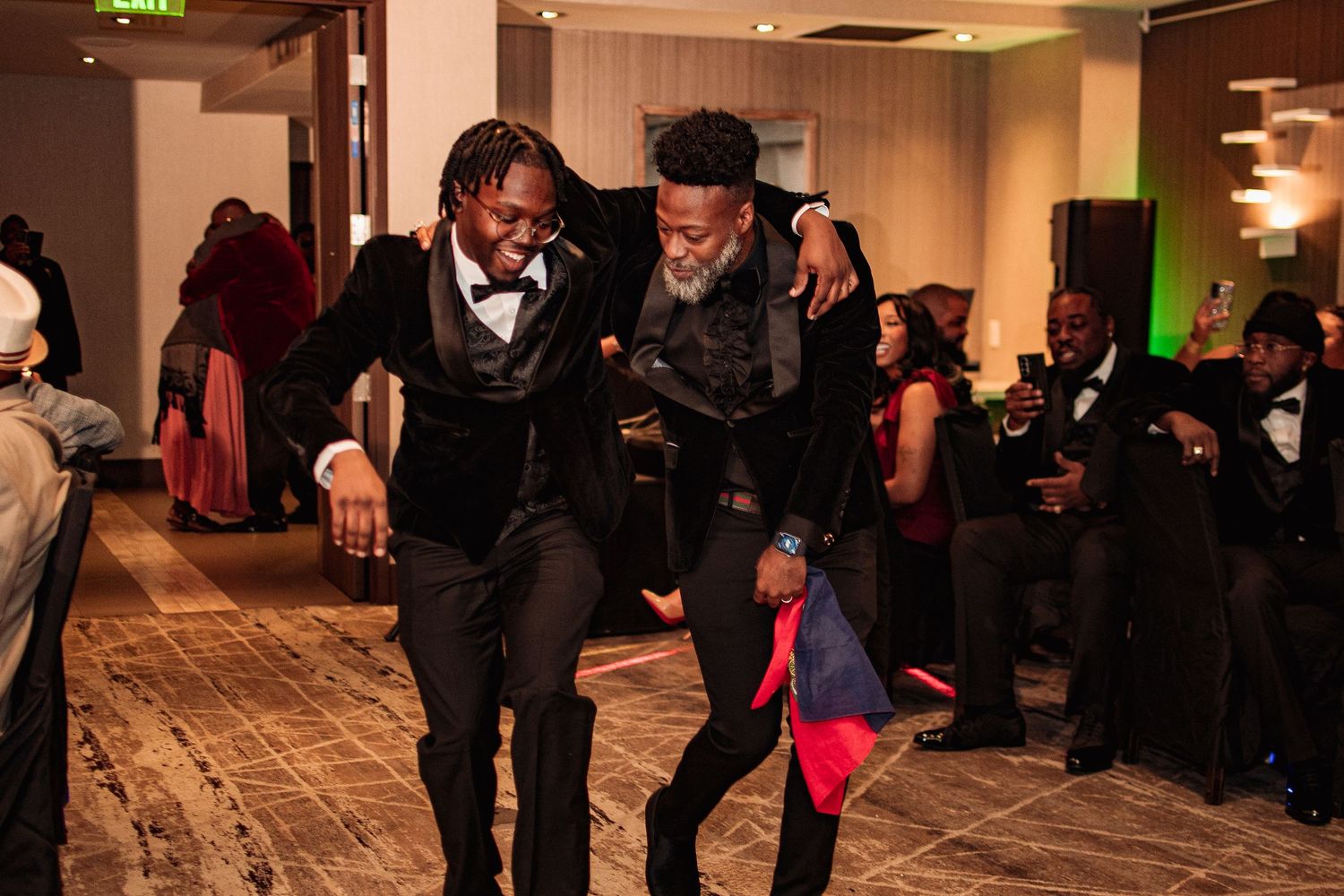 Wedding reception celebration in an elegant indoor venue with guests dancing and socializing.