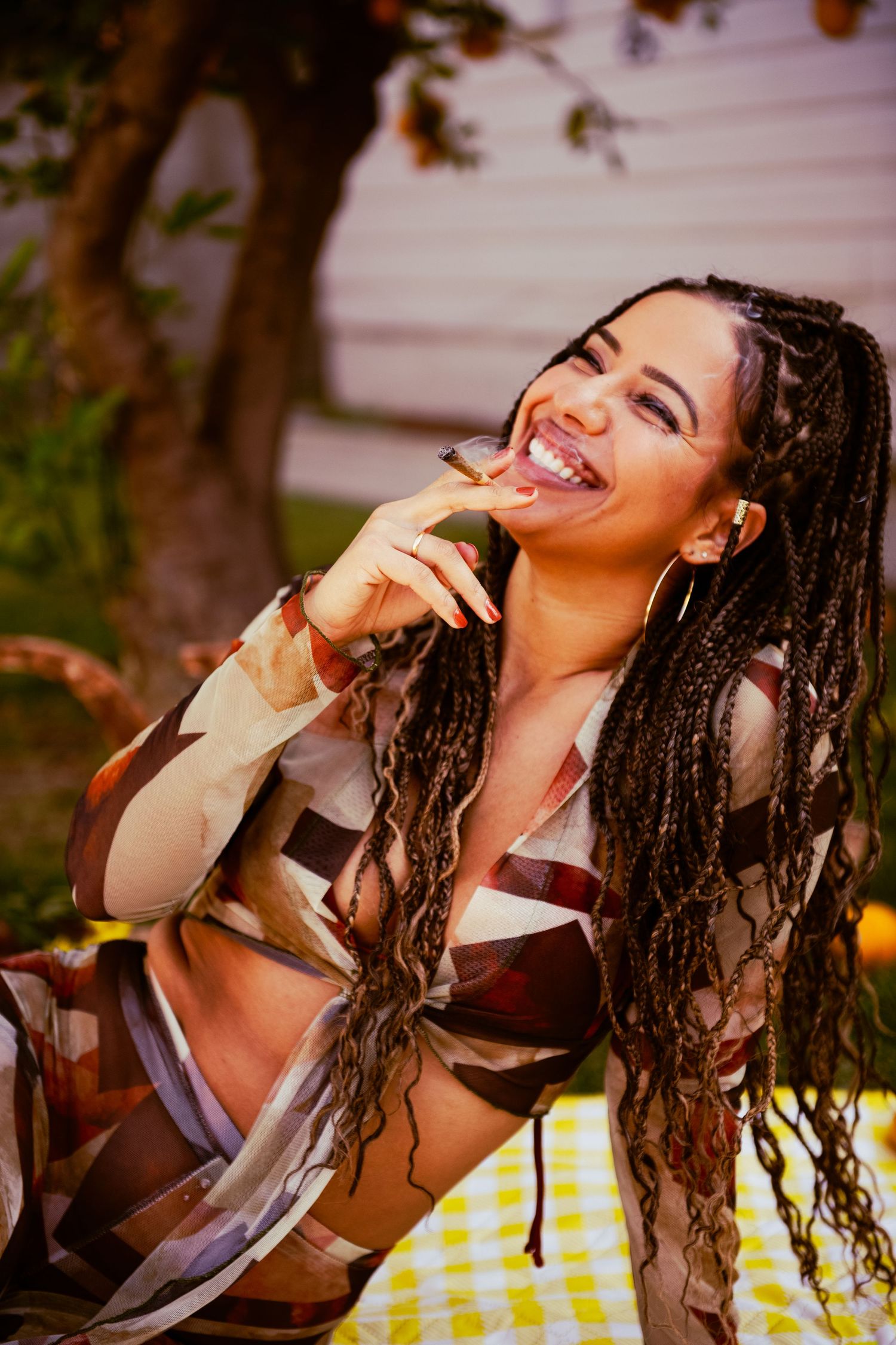 Candid laughter captured during outdoor photoshoot with natural lighting.