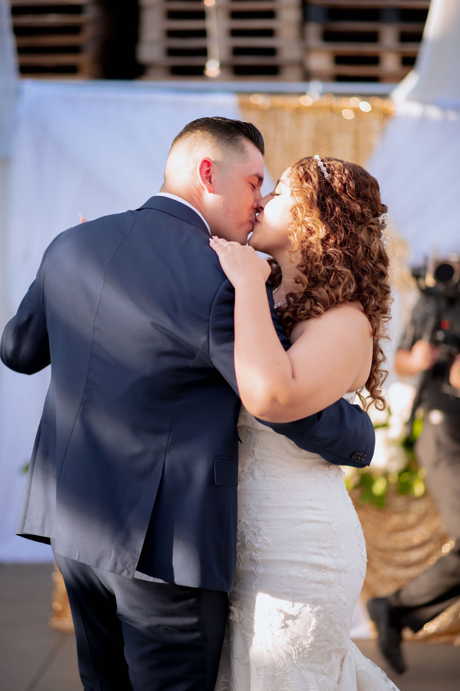 Wedding couple's intimate first dance in decorated reception venue.