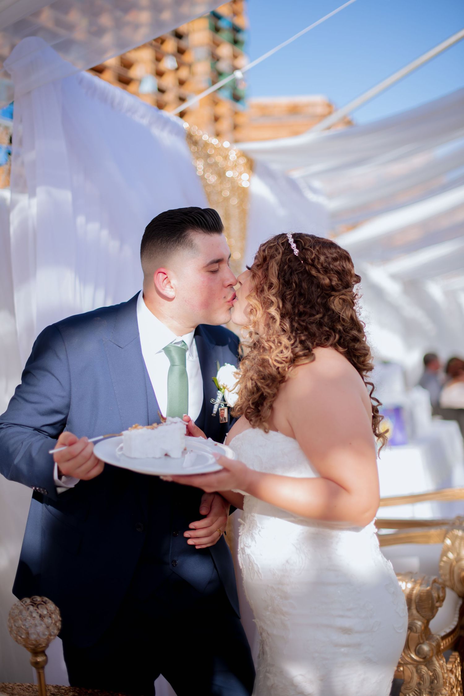 Newlyweds enjoying a fun cake-cutting moment at their reception.