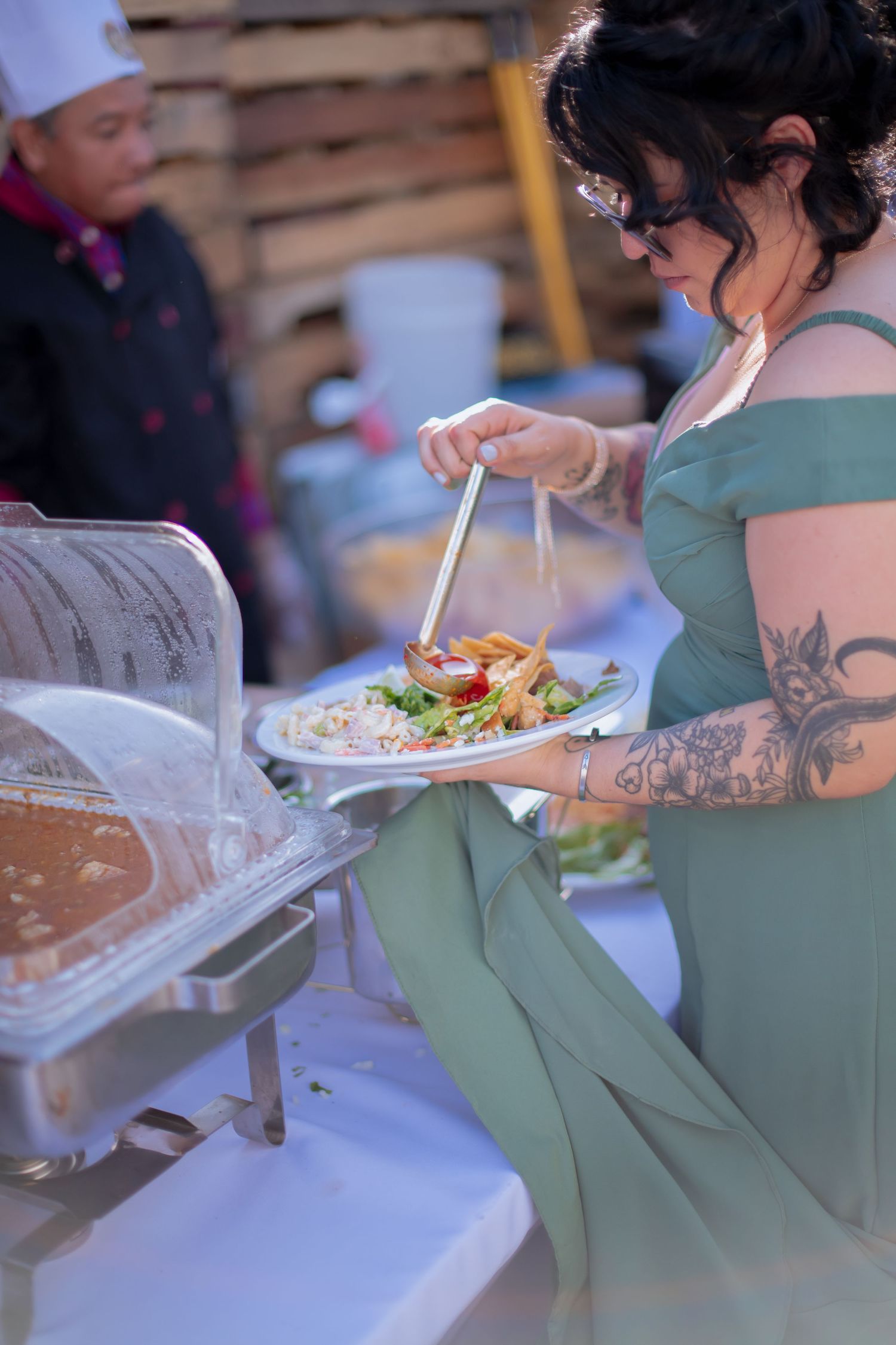 Wedding guests serving themselves food at a buffet line.