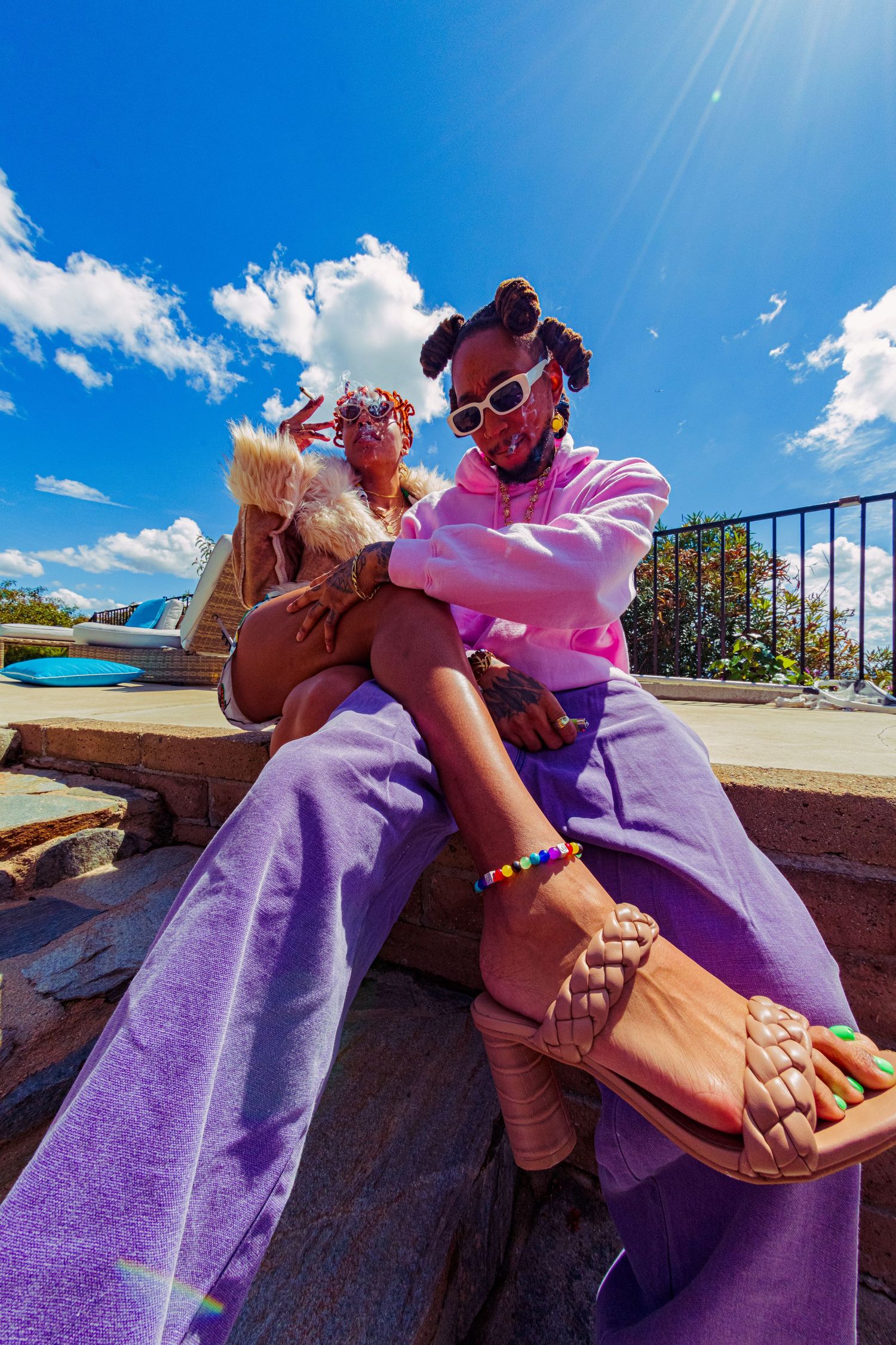 JEFF K%NZ | Recording Artist & Painter Casual outdoor scene showing purple clothing and sandals against a bright blue sky.