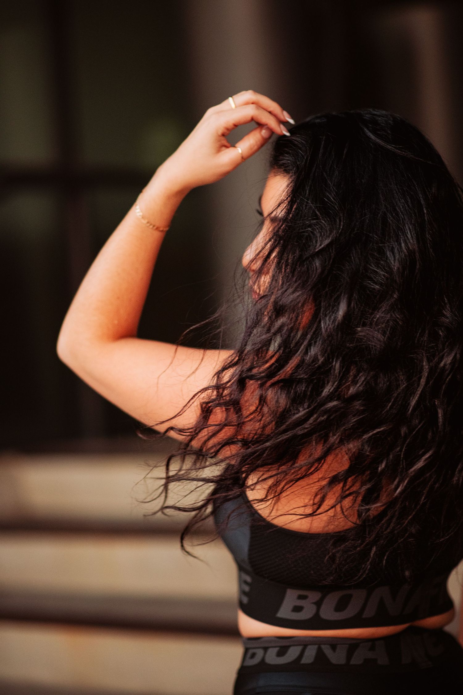 Series of artistic dance poses in black activewear against a blurred background showing fluid movement and expression.