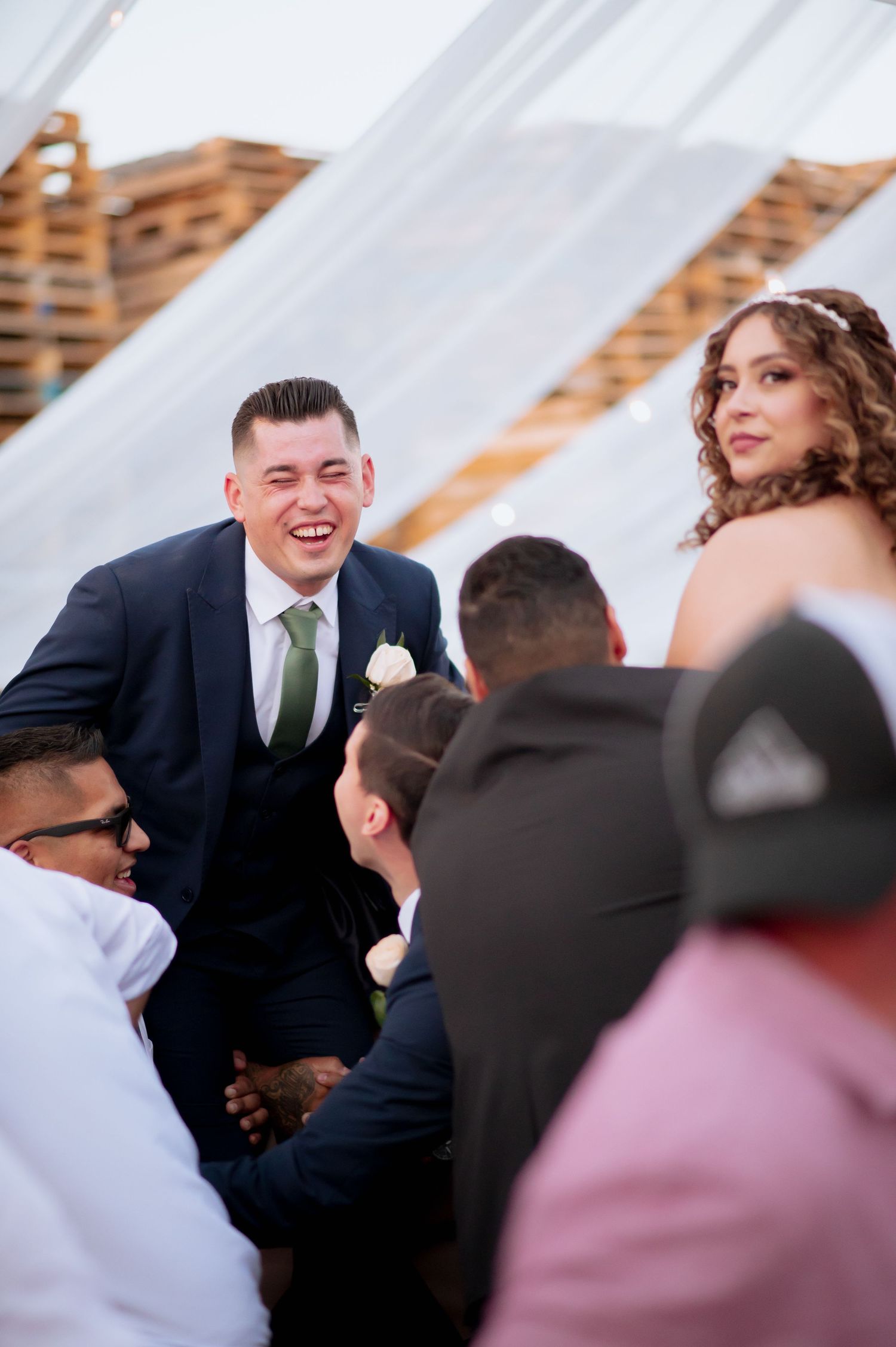 Candid moments between wedding party members during reception festivities.