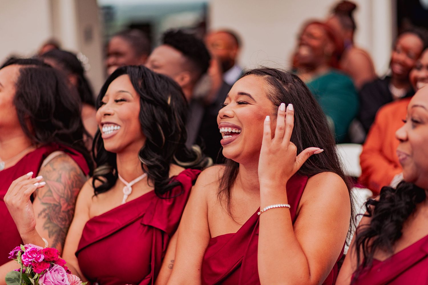 Wedding guests laughing and enjoying themselves during a celebration.