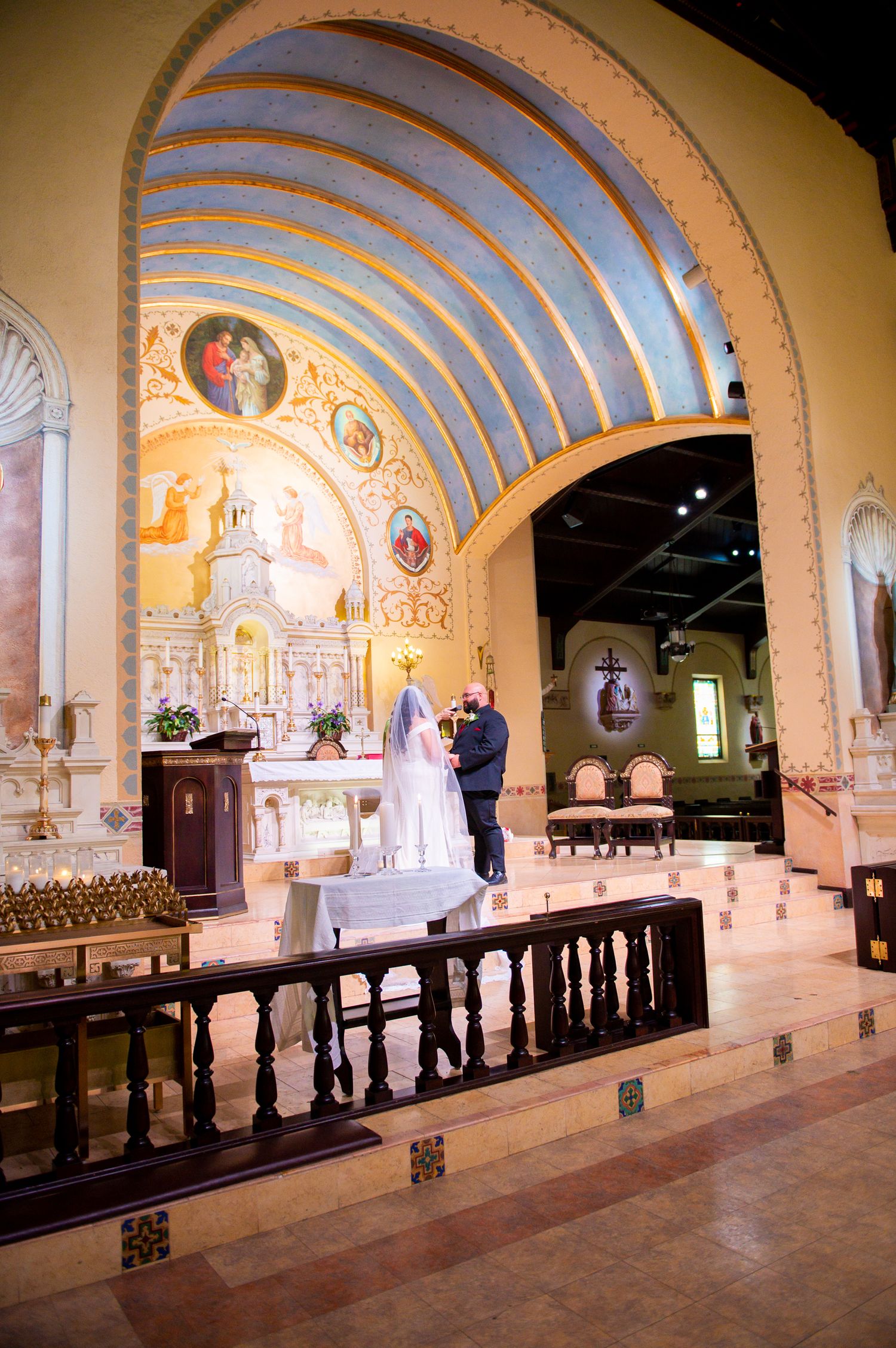 A series of arched chapel photos showing a wedding ceremony in a historic church with painted murals and wooden pews.