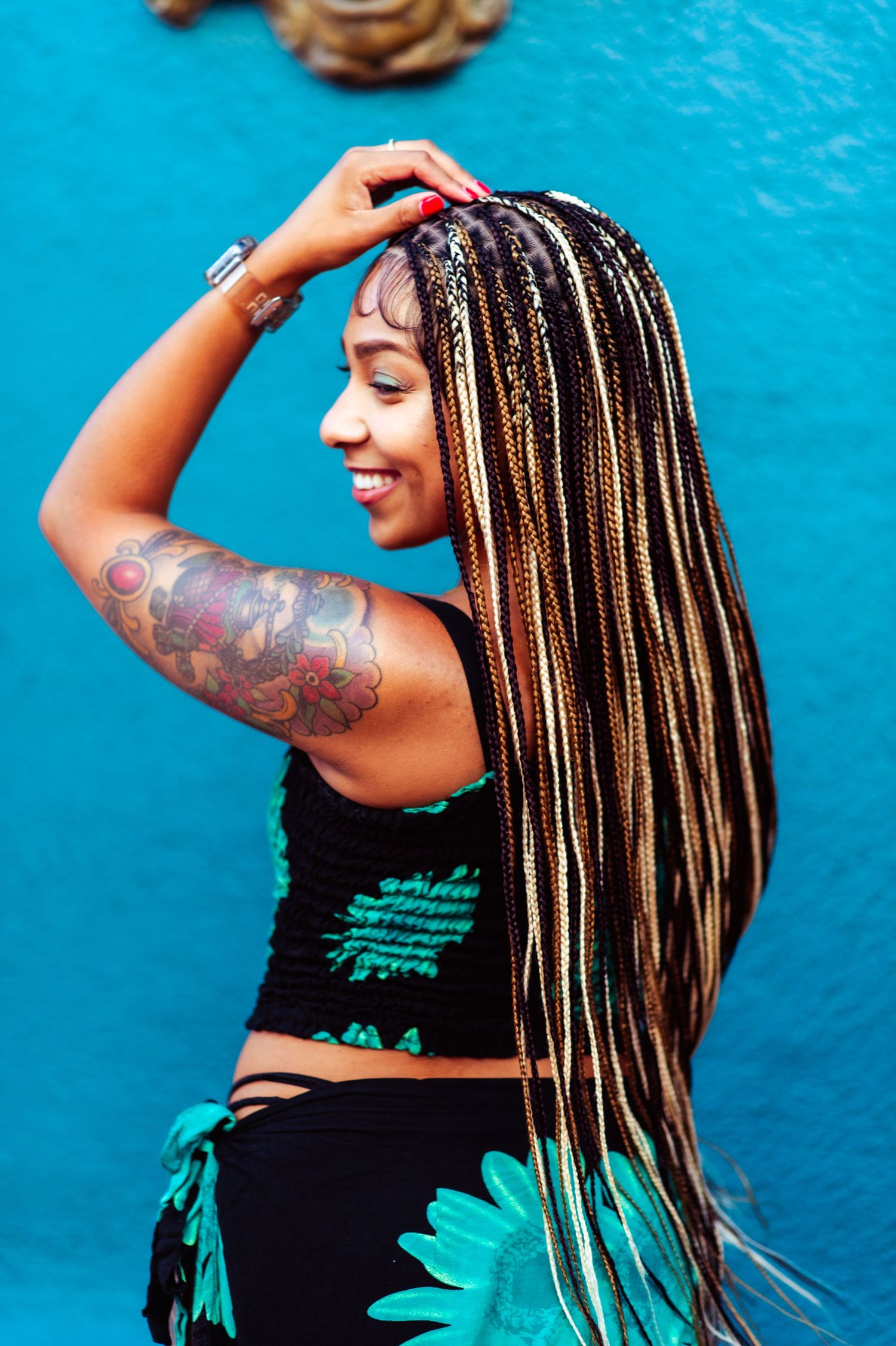 Joyful fashion portraits featuring braided hair and a black dress with turquoise flowers.