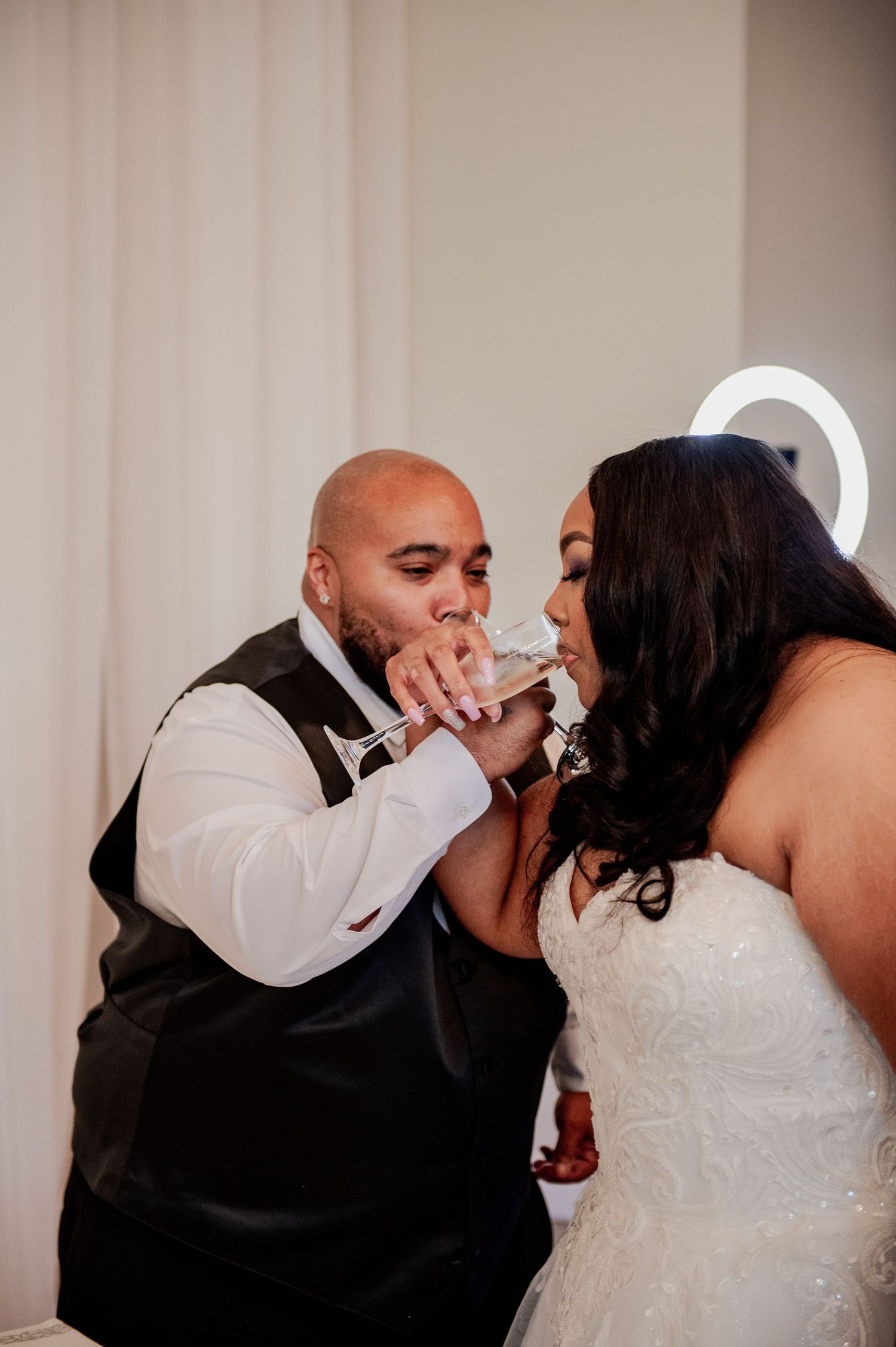 Intimate wedding ceremony kiss sequence with white and purple floral decorations.