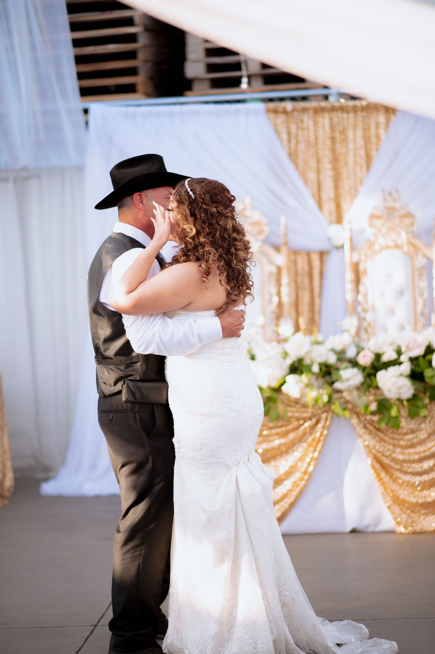 Father daughter dance sequence captures Father and daughter spinning beneath white drapes and chandeliers.