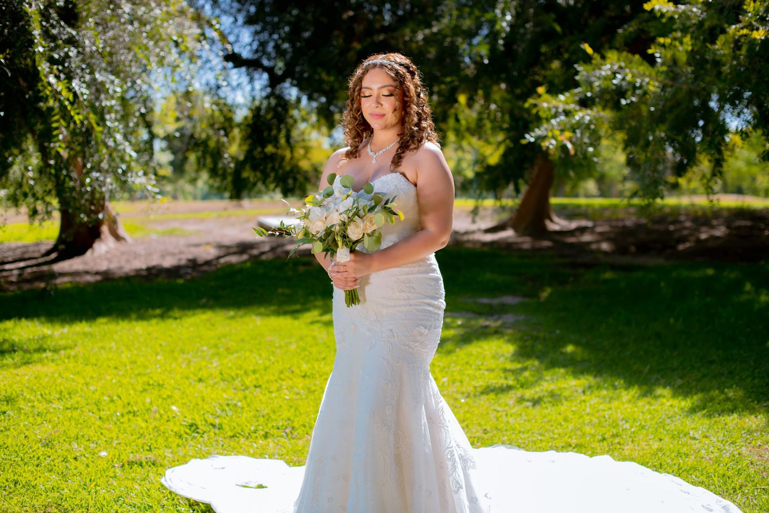 A sunlit wedding photo session featuring a flowing white dress in a lush garden landscape.