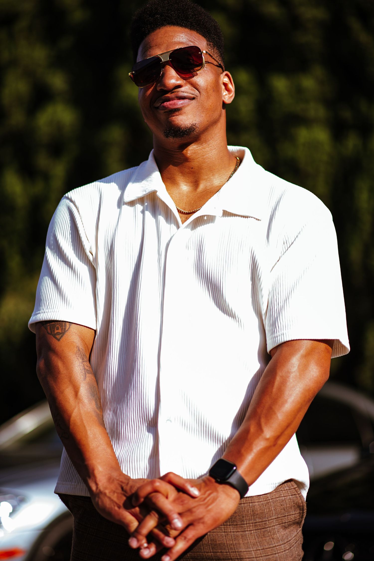 Person in white polo shirt and sunglasses poses outdoors in multiple casual shots.