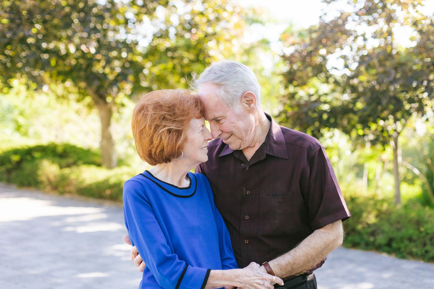 Outdoor photo sequence of senior couple sharing affectionate moments in natural sunlight.