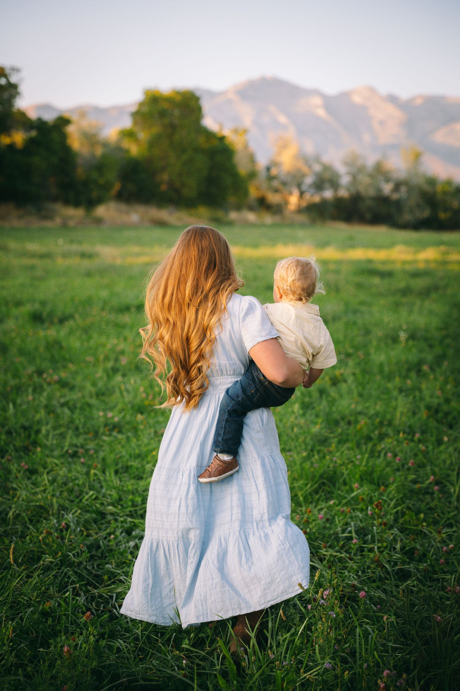 A collection of intimate outdoor portraits showing figures in white dresses against a mountain backdrop at golden hour.