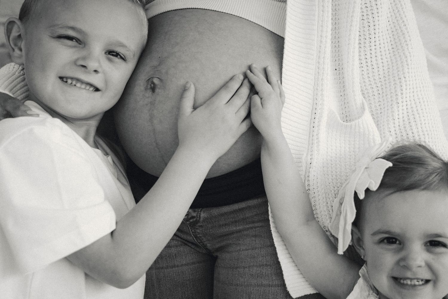 Black and white close-up shots of family embracing during maternity photoshoot.
