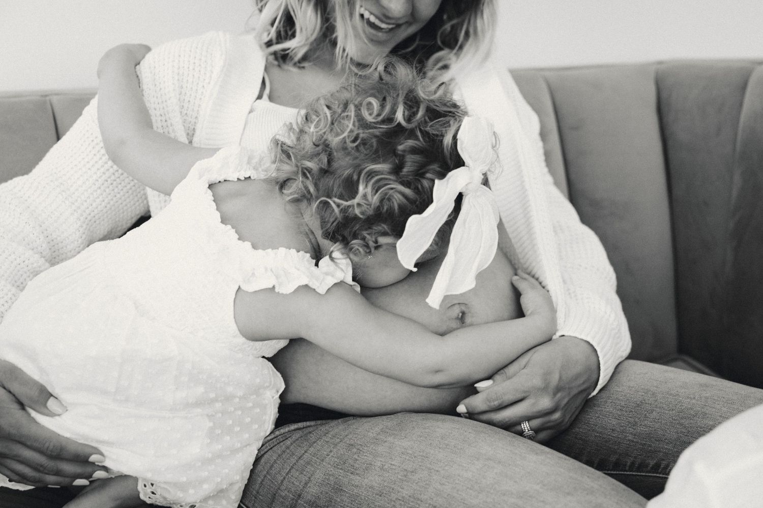 Sweet black and white photos of intimate family moments on a couch.