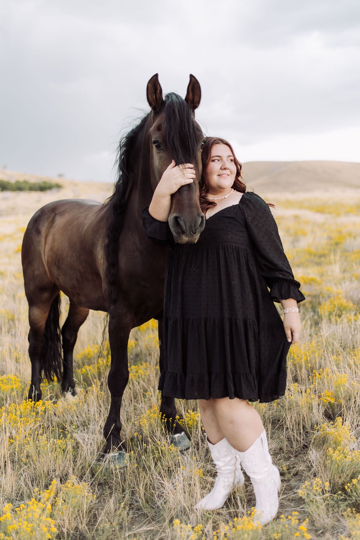 A sequence of artistic shots featuring a person in black with a majestic dark horse in a wildflower meadow.
