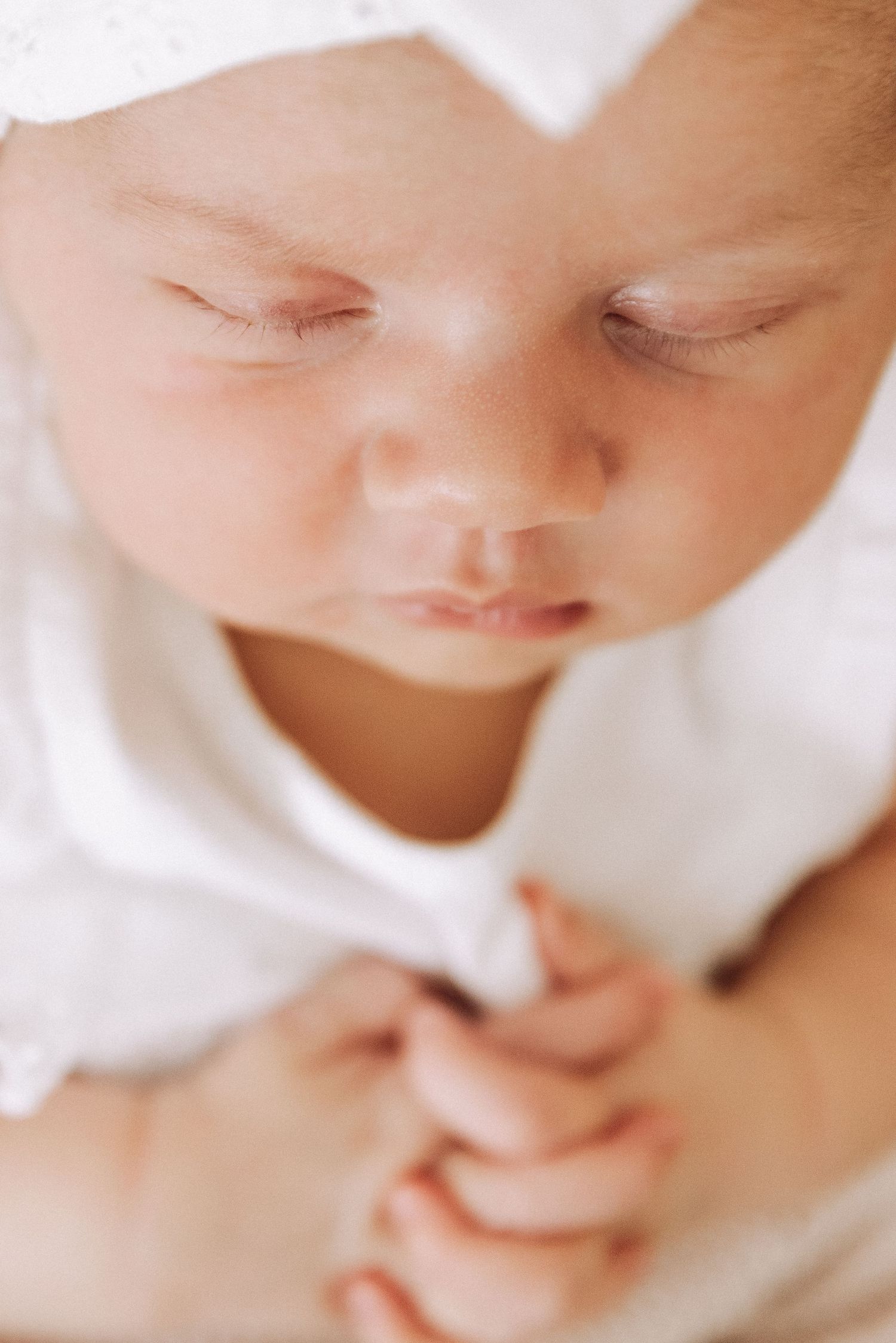 Close-up shots of a sleeping baby's face in soft natural lighting.
