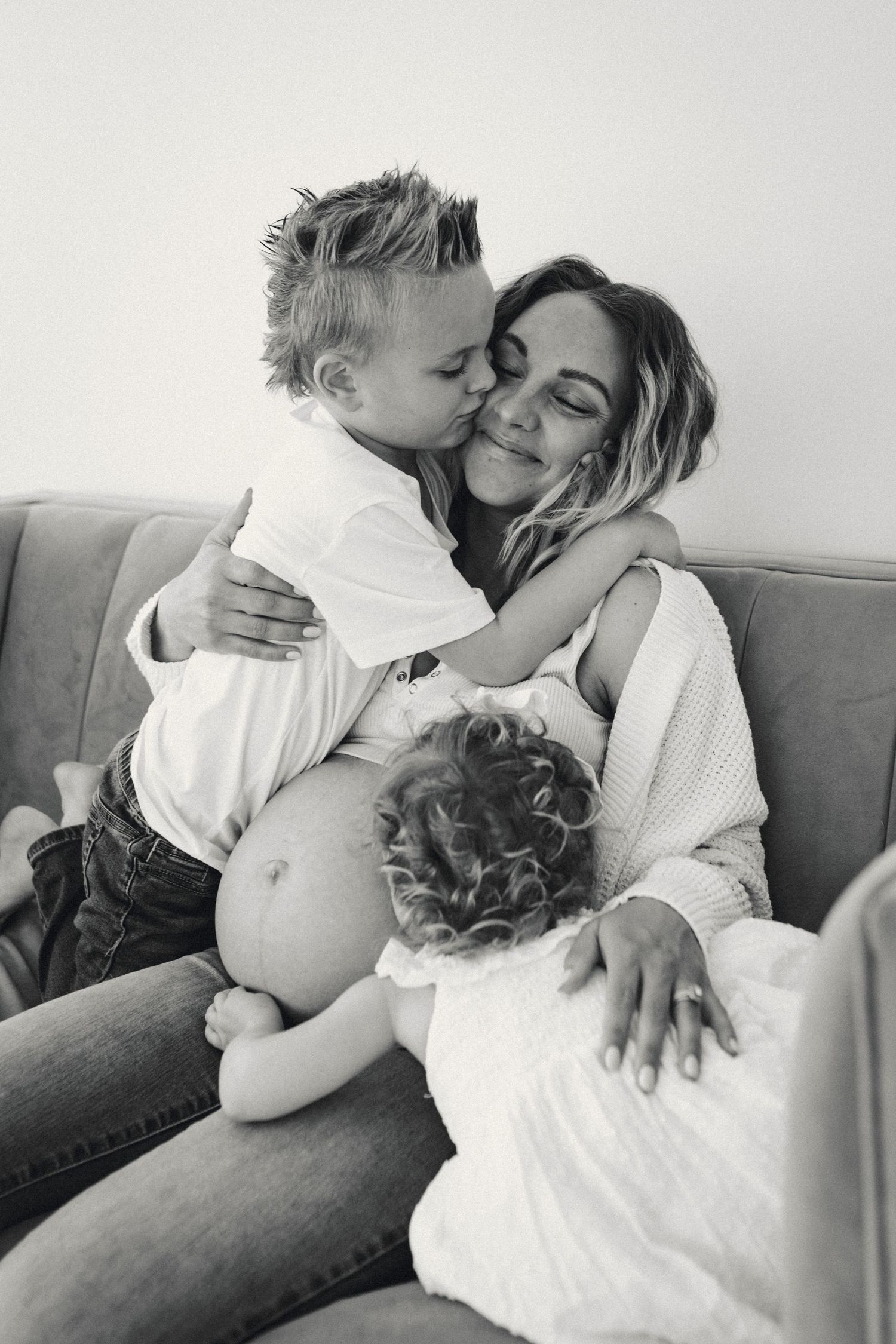 Intimate black and white photos showing affectionate family interactions.