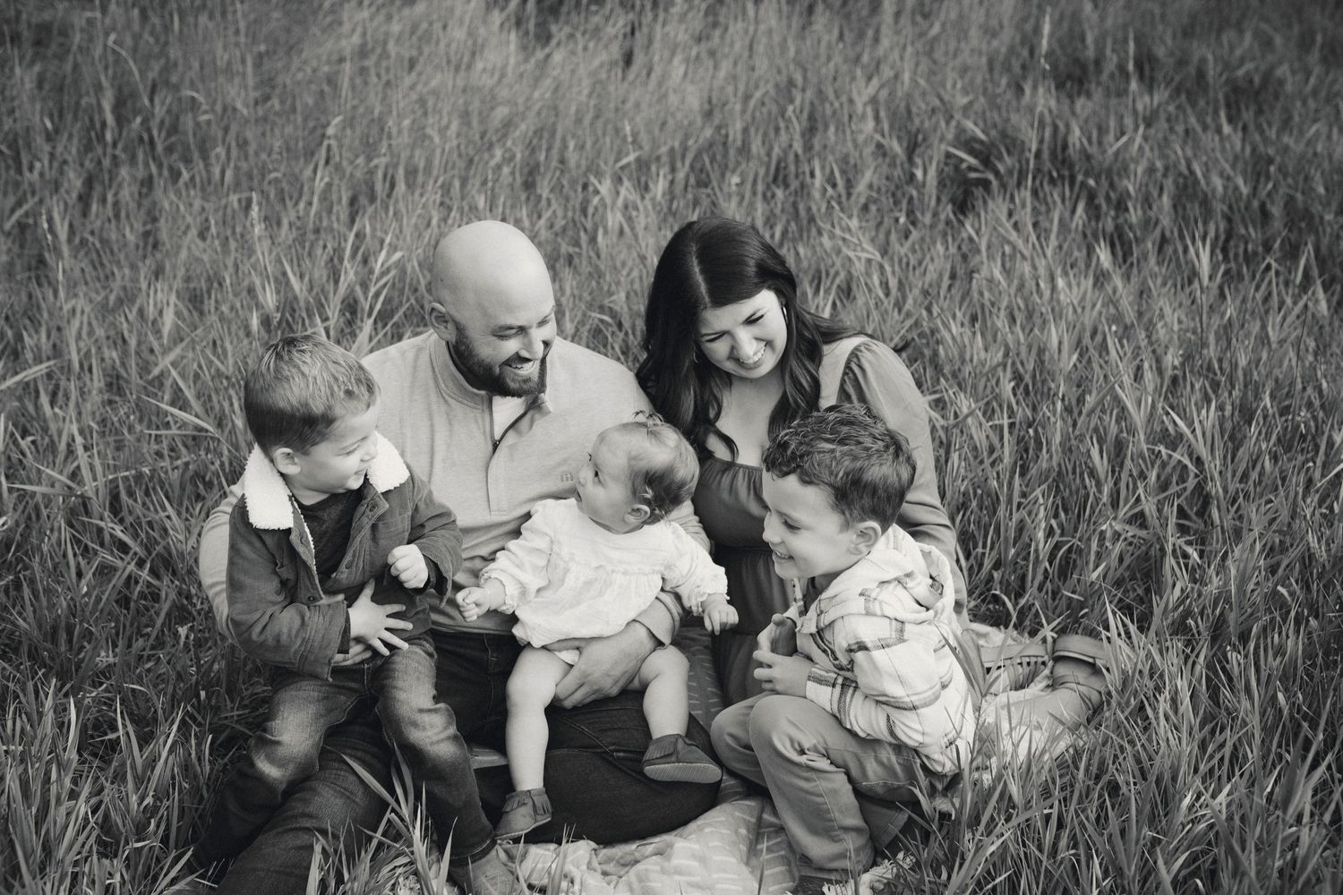 Black and white family photos in a rustic field setting.