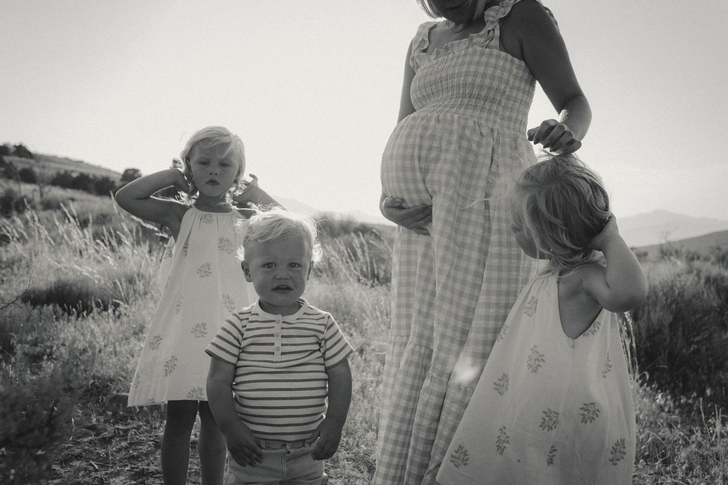 Vintage black and white photographs capturing family moments in an outdoor setting.