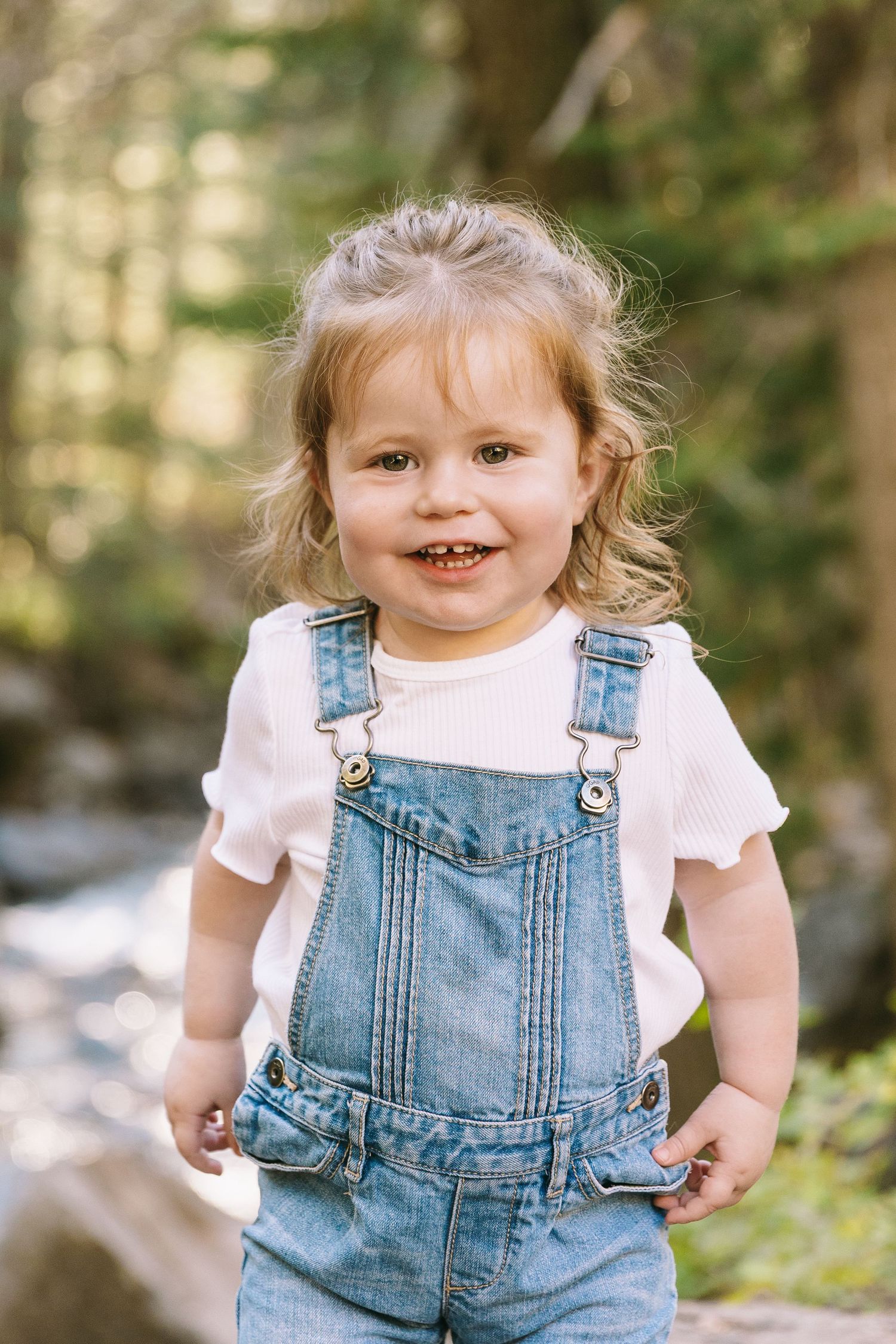 Three sequential photos showing a toddler in denim overalls and white shirt playing outdoors in natural lighting.