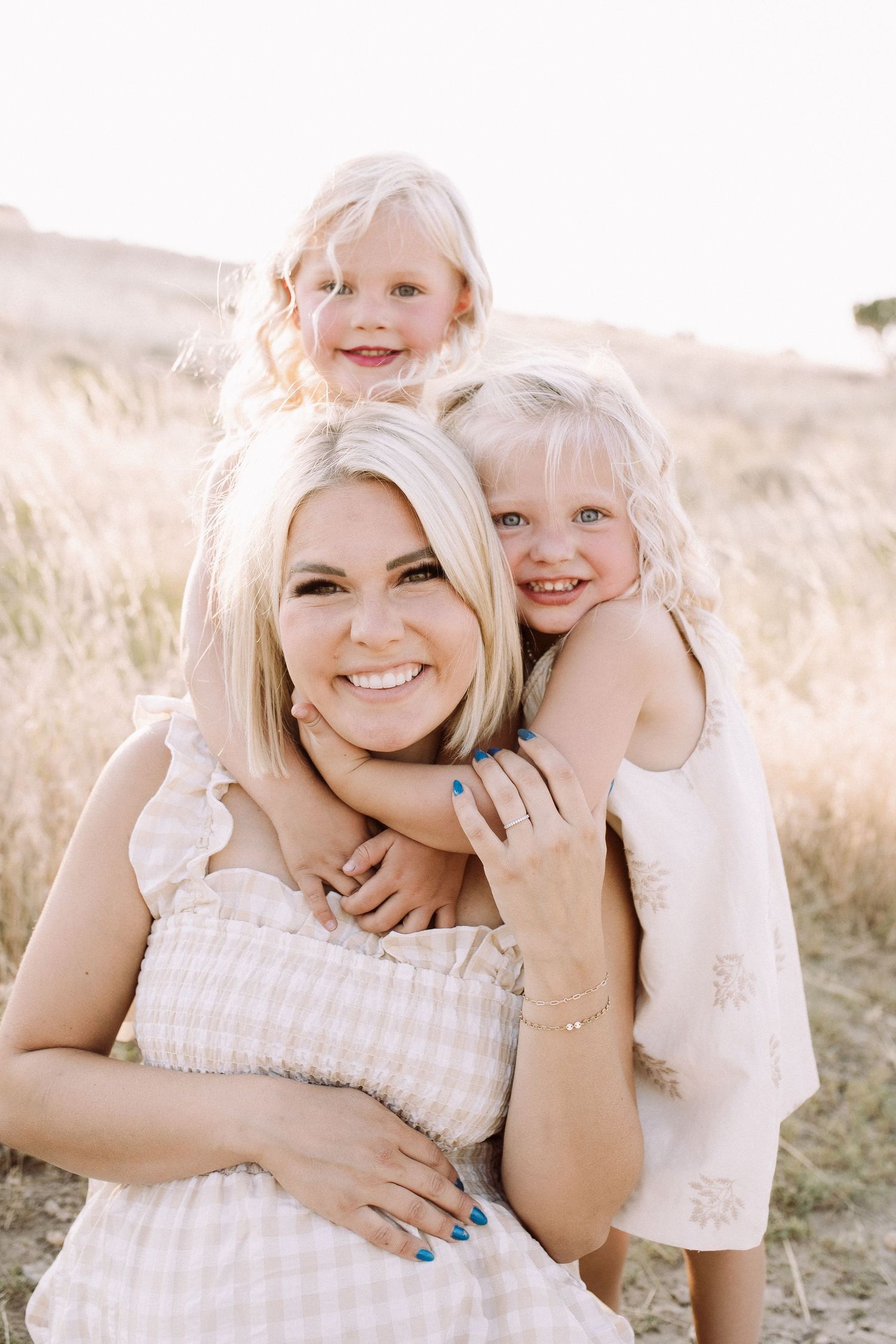 Candid family moments captured in warm sunlight against desert scenery.