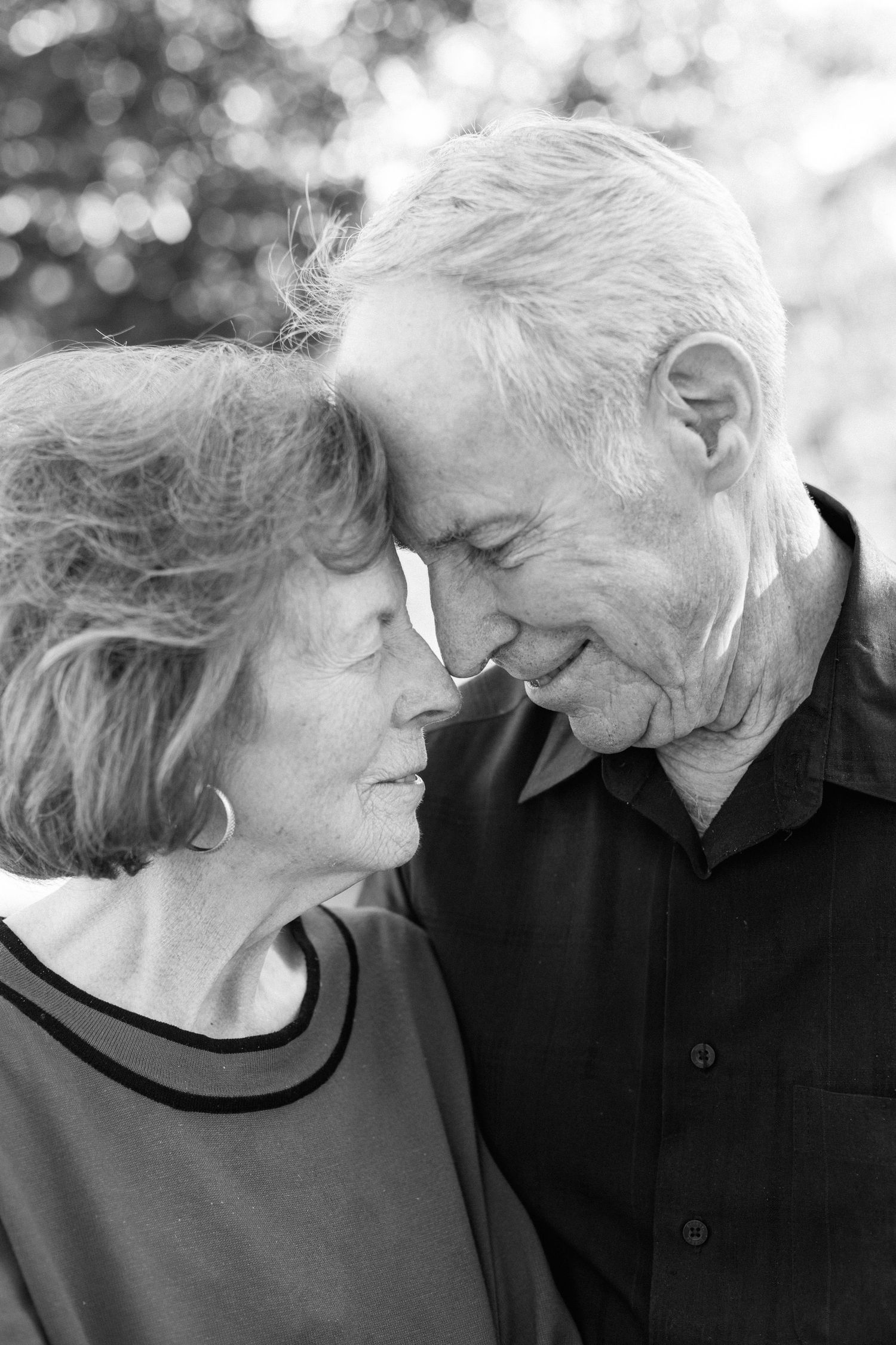 Black and white photo series showing tender moments between an elderly couple in close embrace.