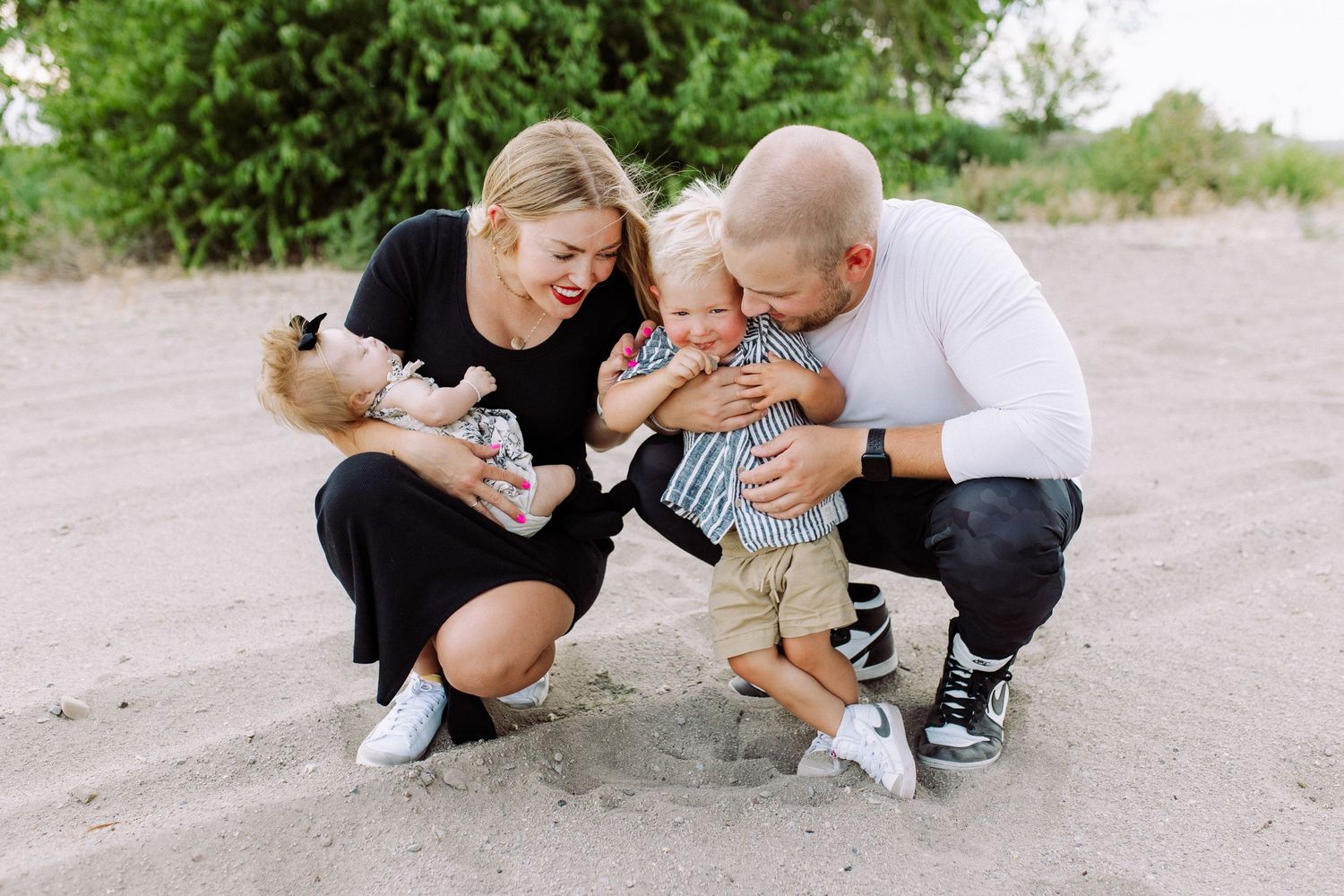 Candid family moments captured on a sandy path outdoors.