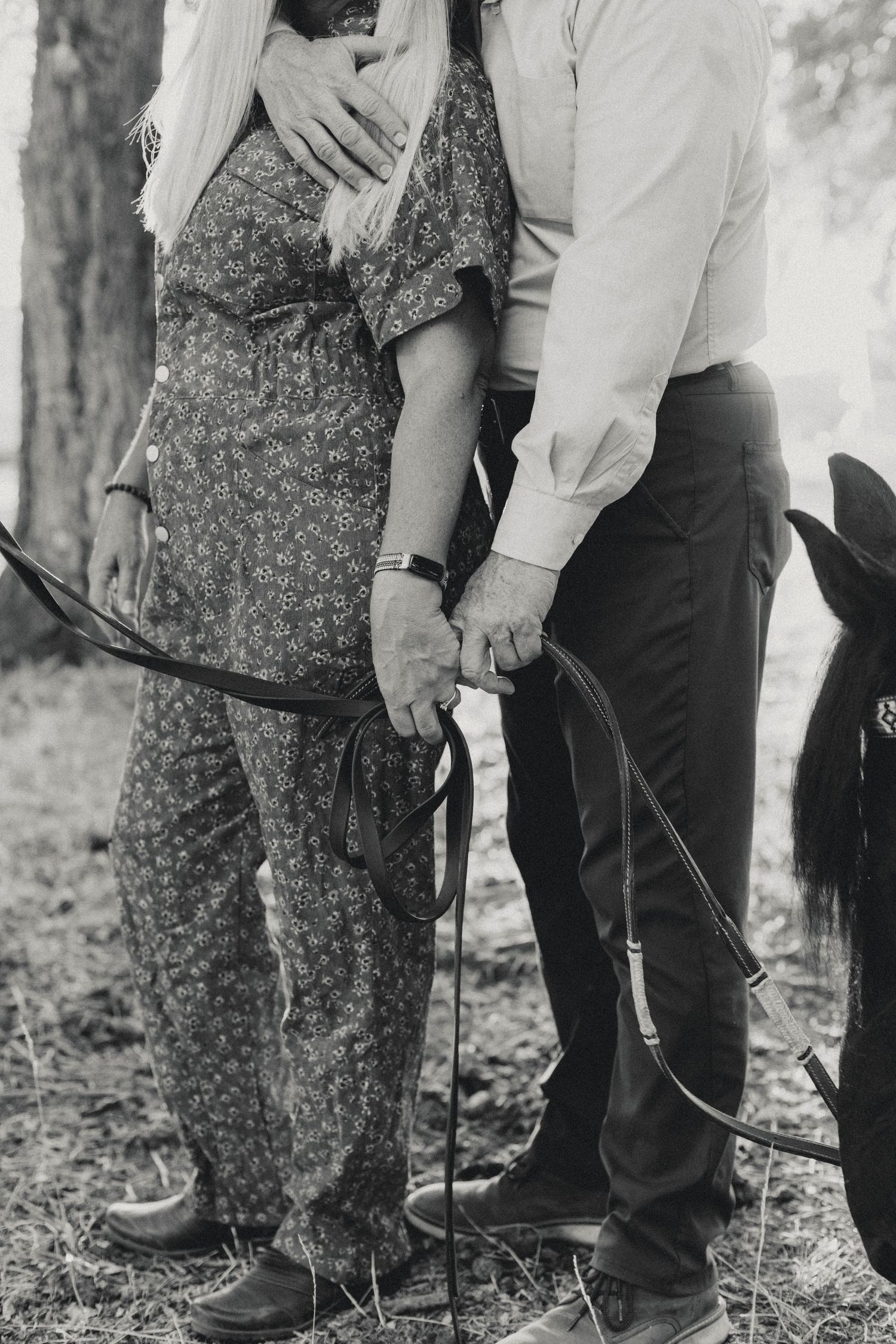 Black and white portrait series showing tender moments between a couple near trees.