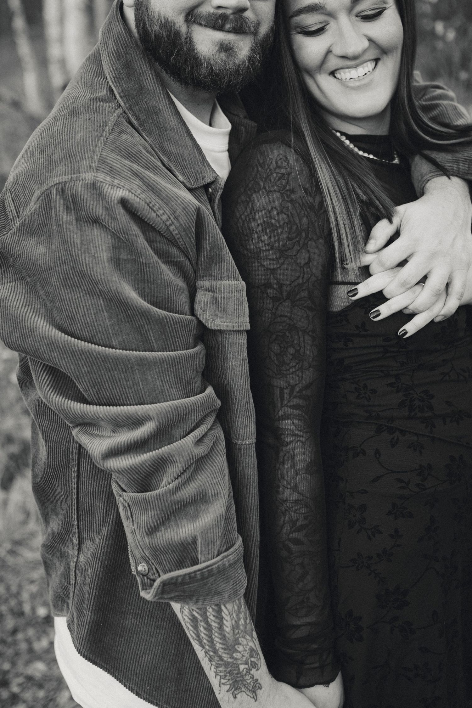 Close-up of couple sharing intimate moment wearing corduroy and lace in black and white.
