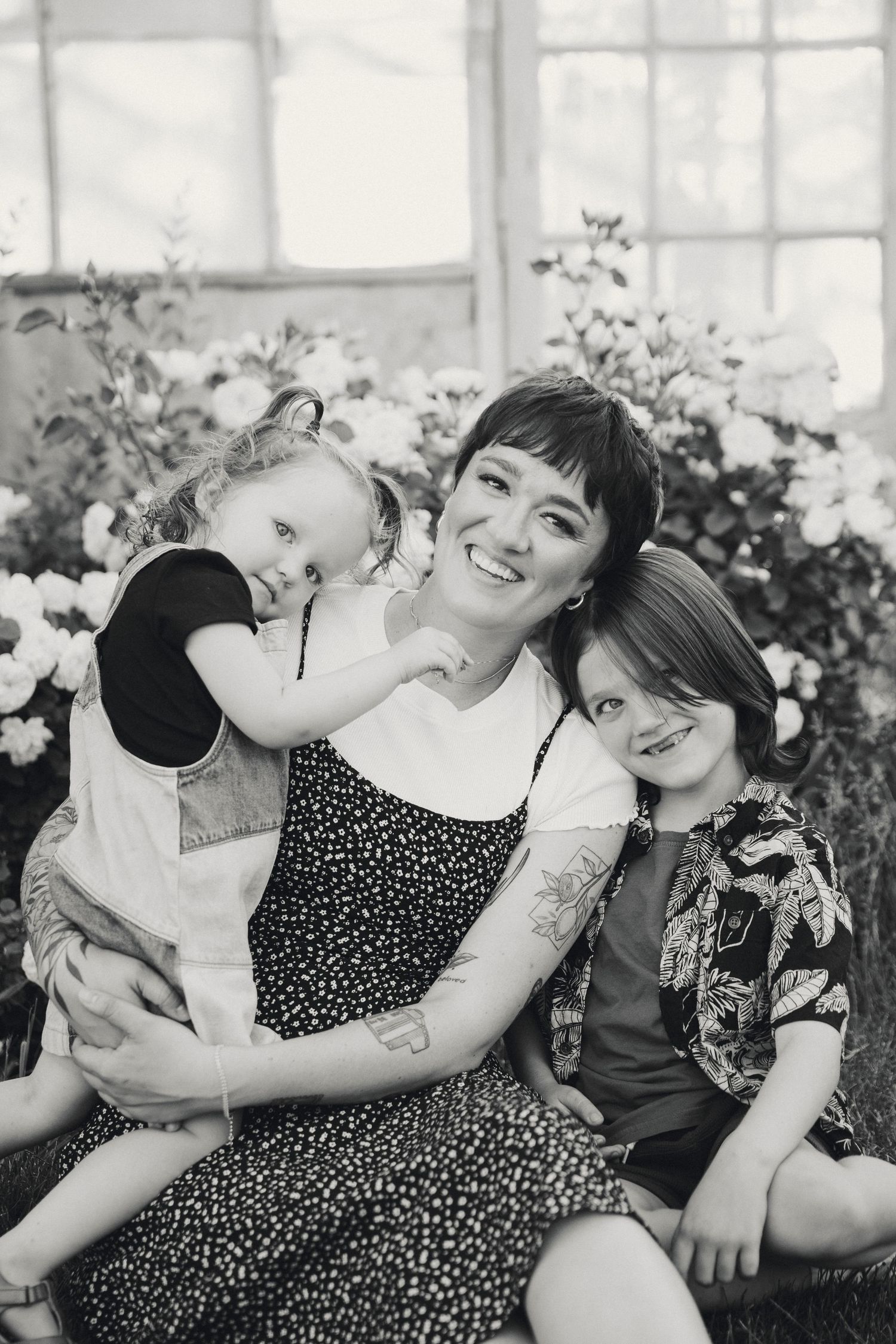 Black and white photo series showing playful laughter and embraces between two people in a polka dot dress.